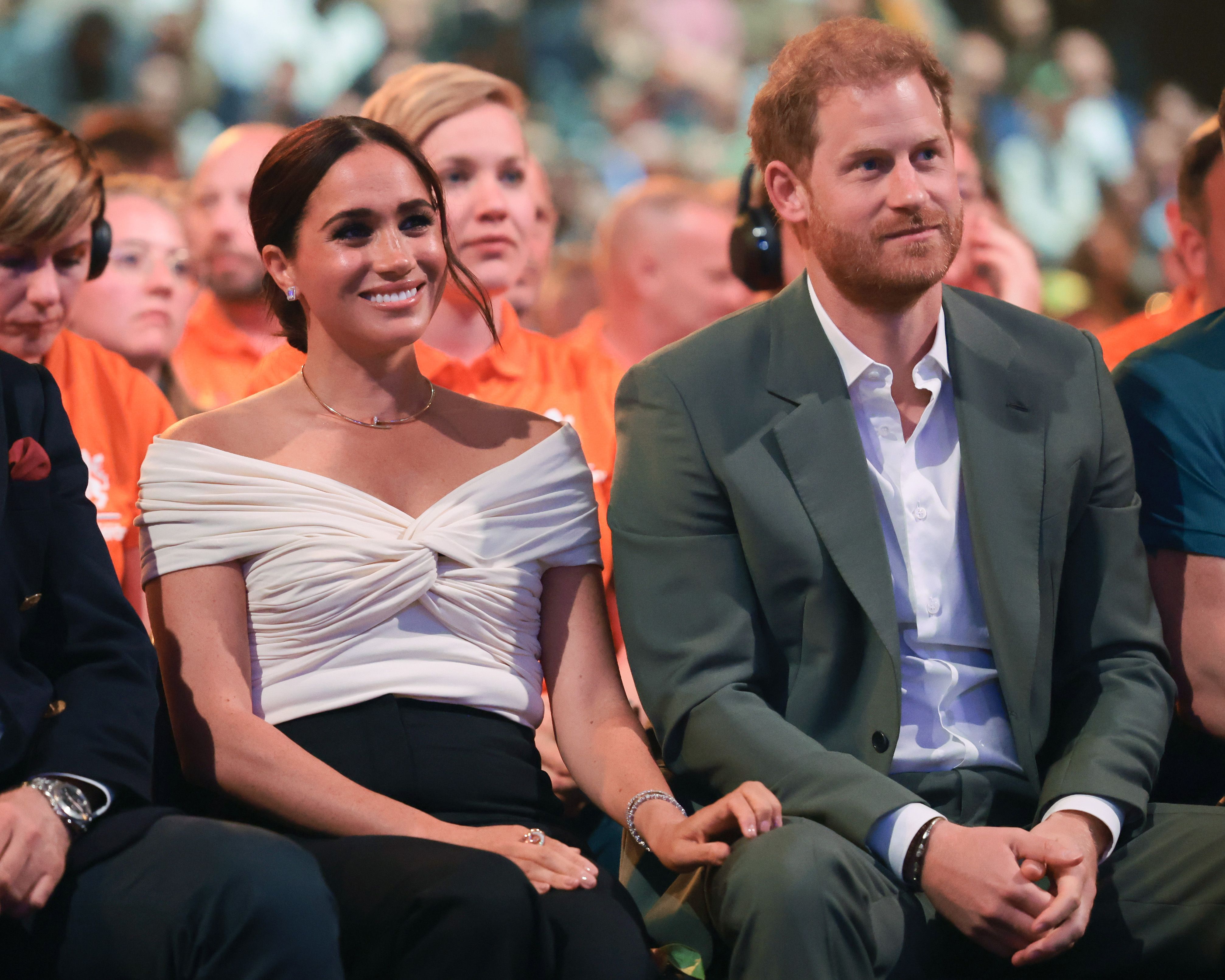 Meghan Markle sits next to Prince Harry.