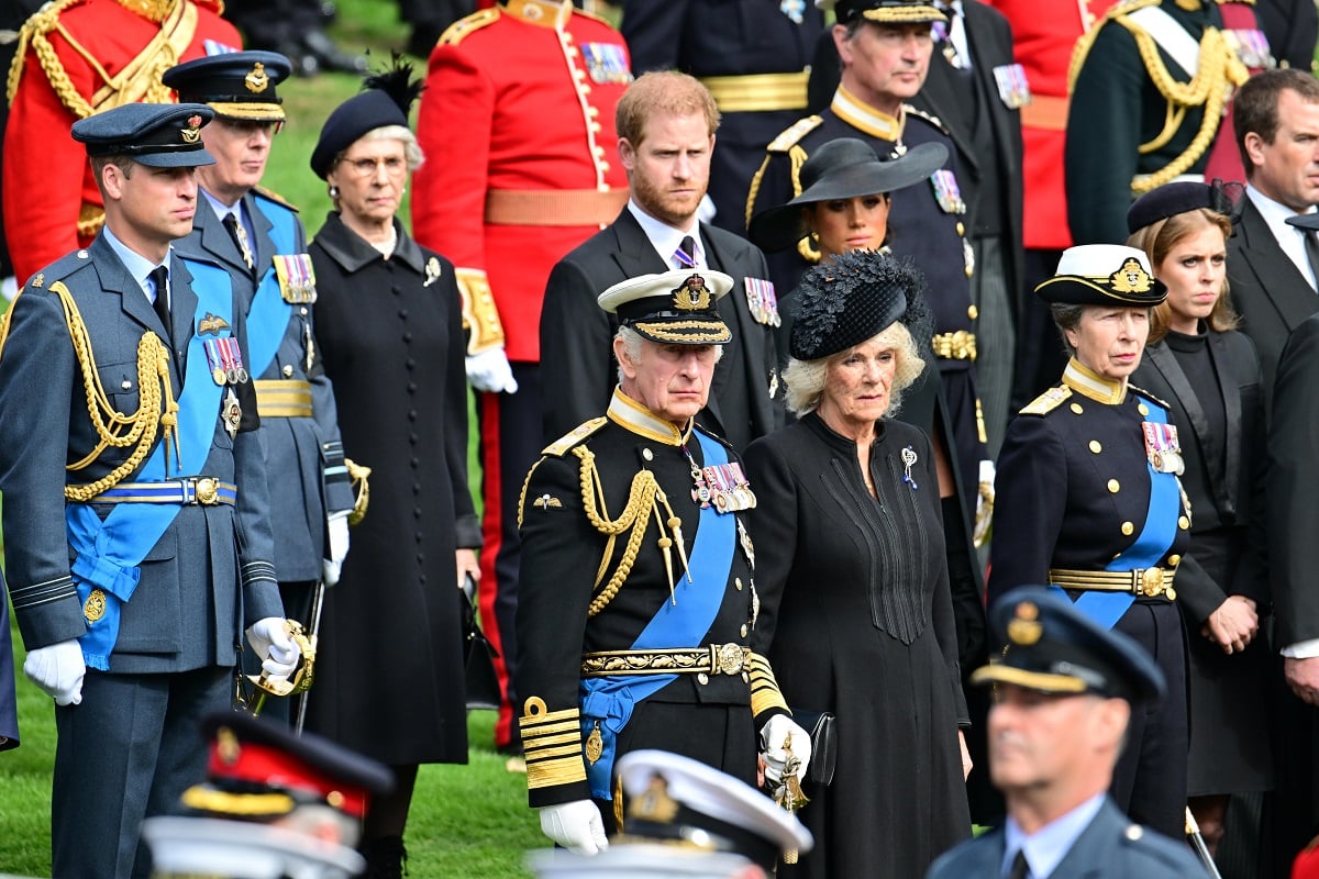 Members of the royal family including Prince Harry and Meghan Markle observe the coffin of Queen Elizabeth II as it is transferred from the gun carriage to the hearse