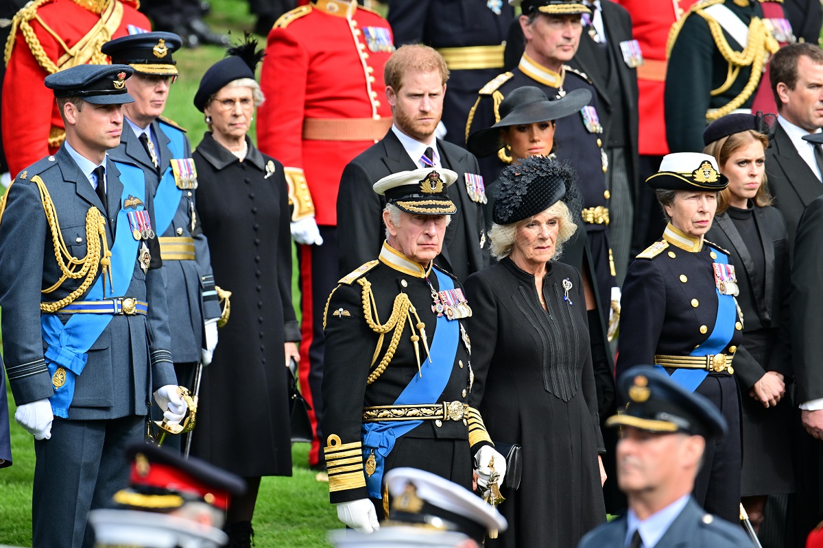 Members of the royal family including Prince Harry and Meghan Markle observe the coffin of Queen Elizabeth II as it is transferred from the gun carriage to the hearse