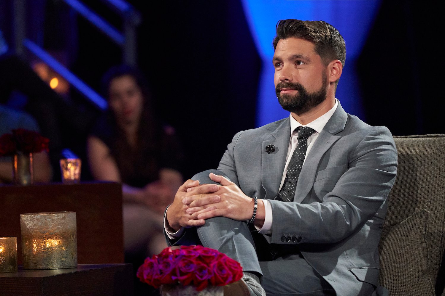 'Bachelor in Paradise' Season 8 star Michael Allio sitting on stage for 'The Bachelorette' Men Tell All