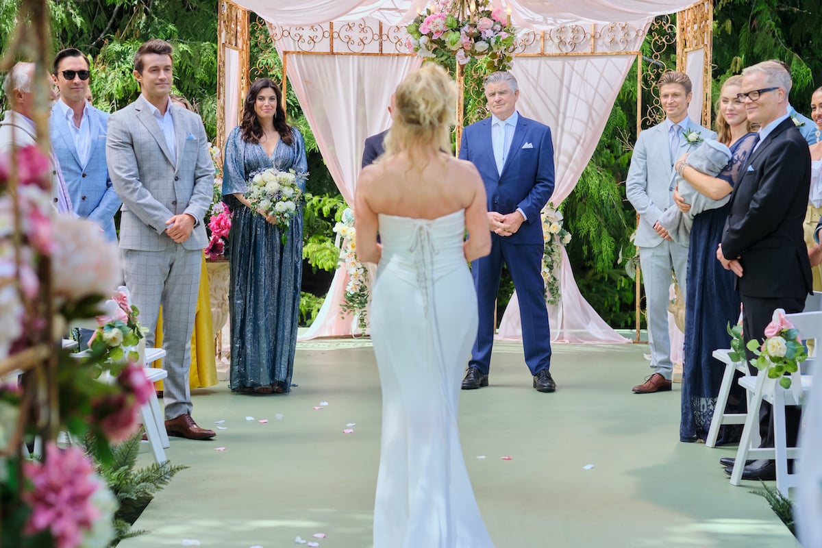 Megan (with back to the camera) walking down the aisle at her wedding to Mick in the 'Chesapeake Shores' Series finale