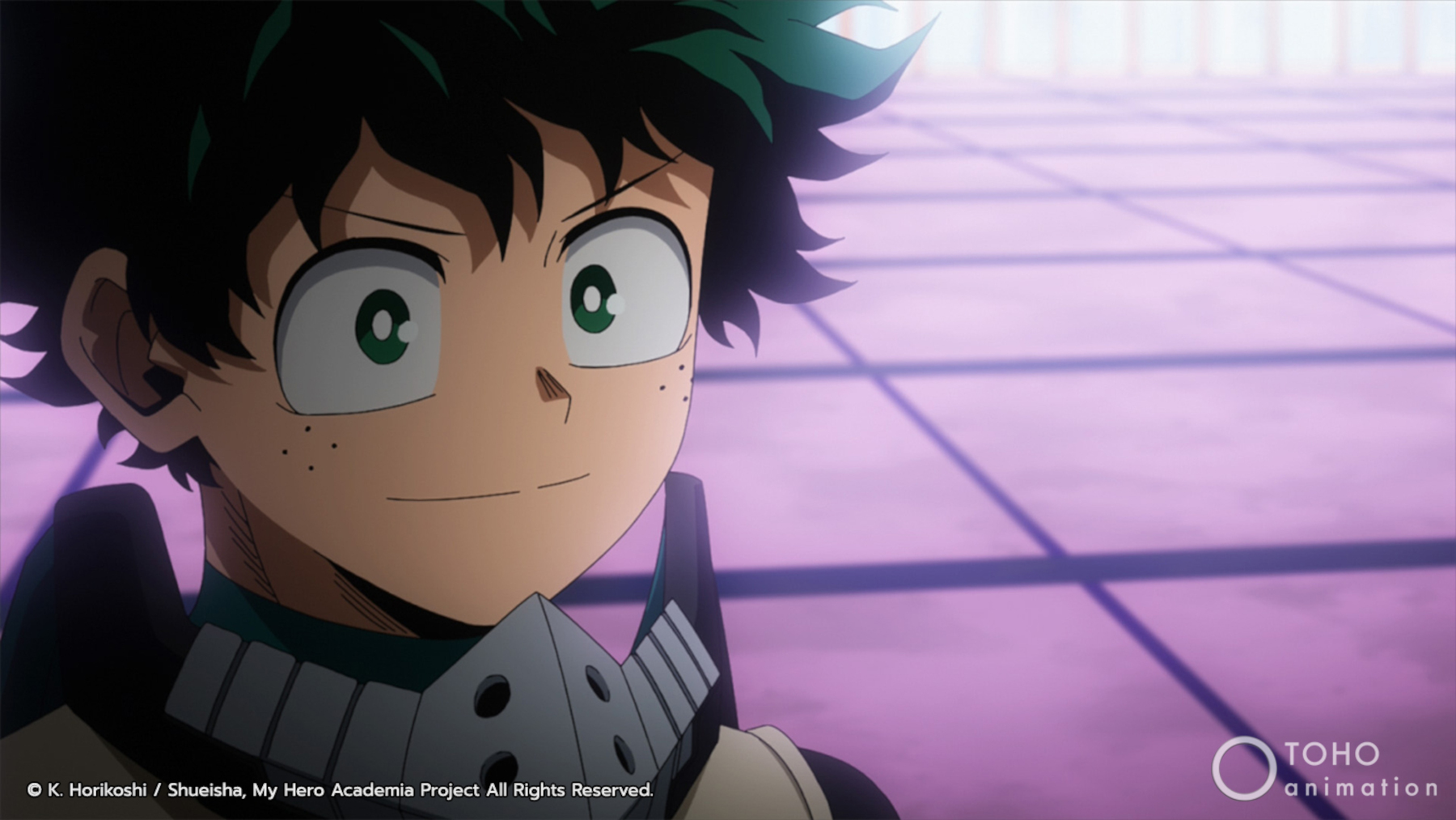 Deku in 'My Hero Academia' for our article about his doctor. He's standing on a purple, tiled floor and smiling.
