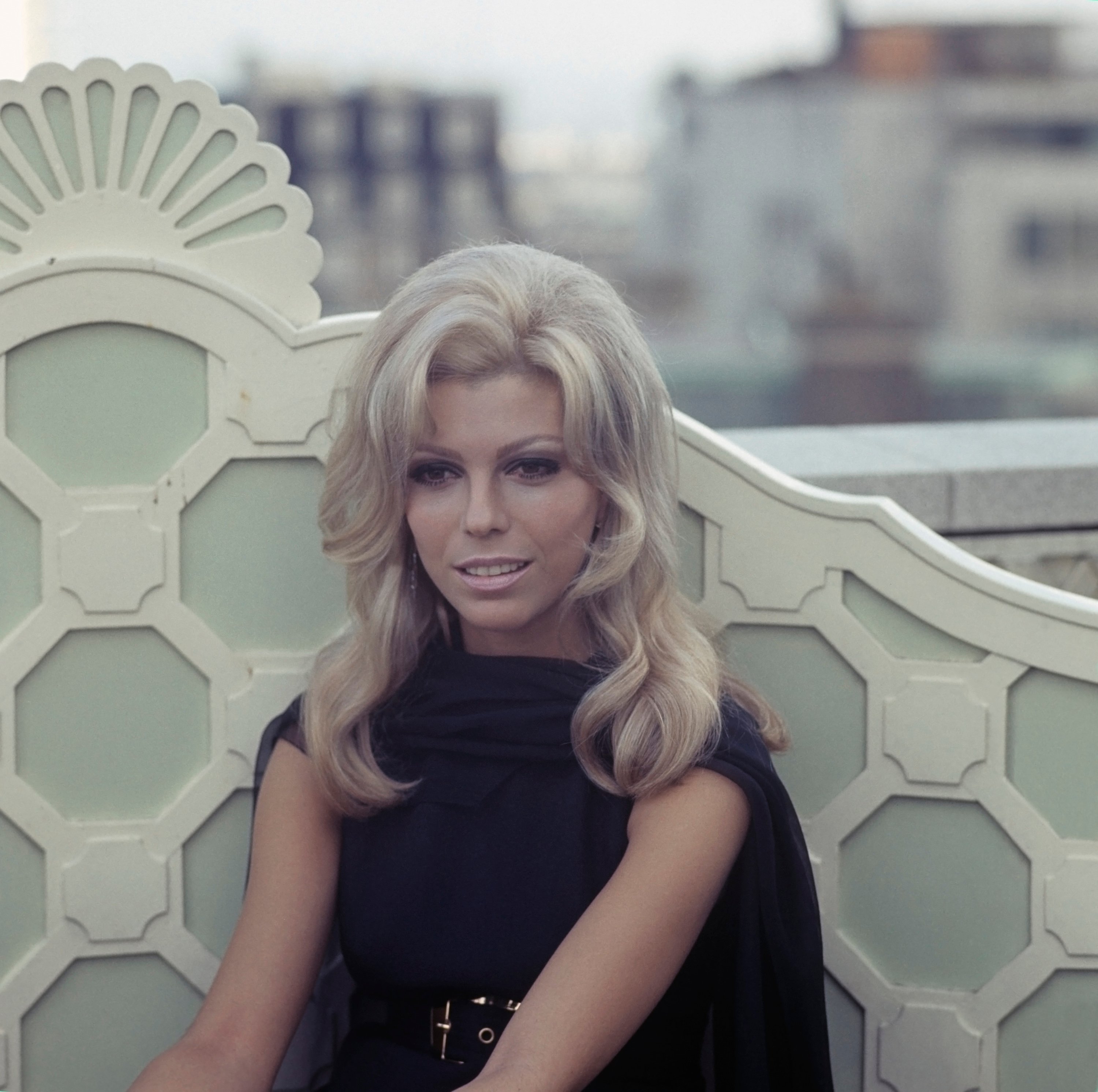 American singer and actress Nancy Sinatra posed at a hotel roof garden in London
