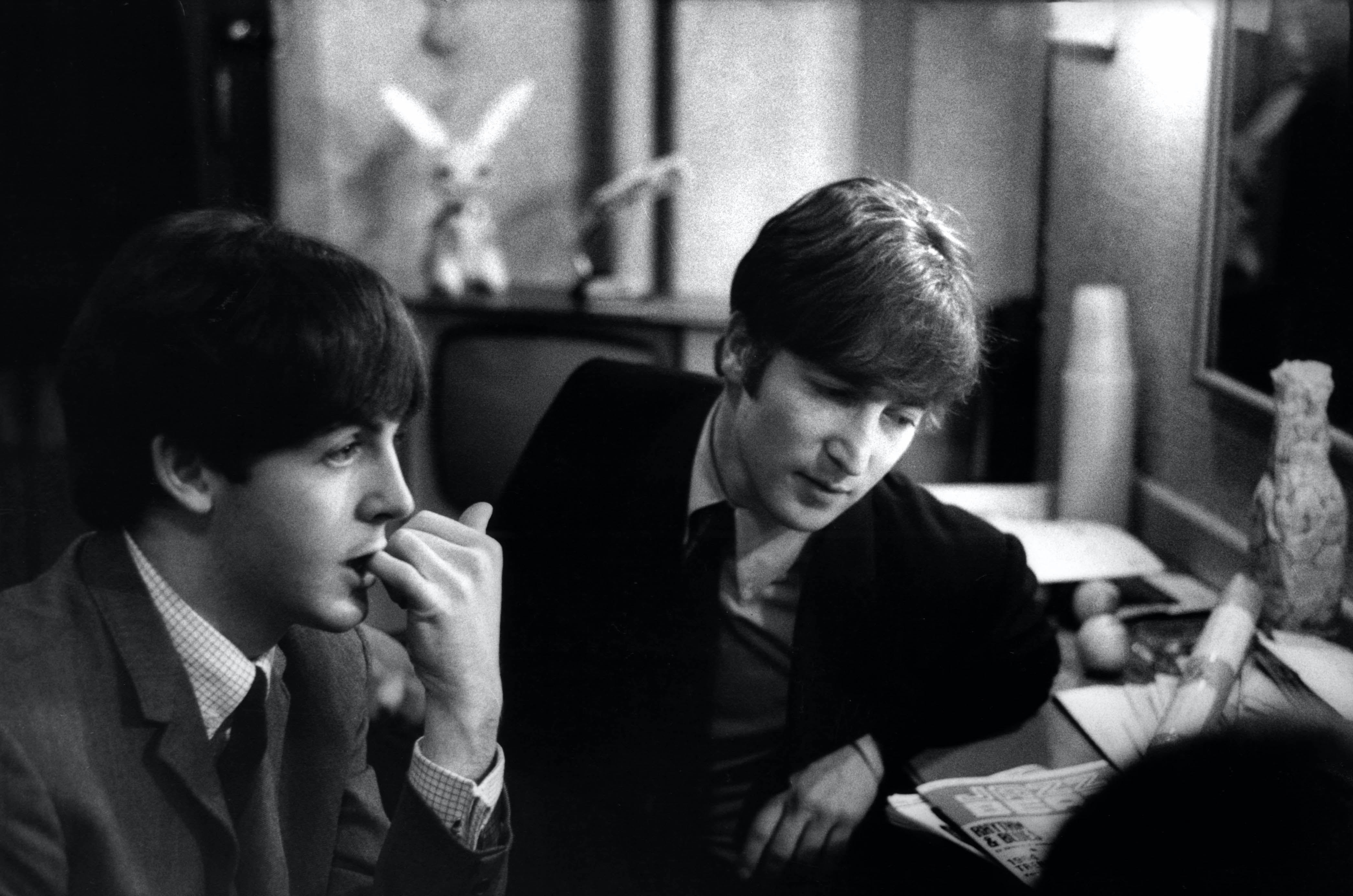 Paul McCartney and John Lennon (1940-1980) from The Beatles posed backstage at the Finsbury Park Astoria, London during the band's Christmas Show residency on 30th December 1963