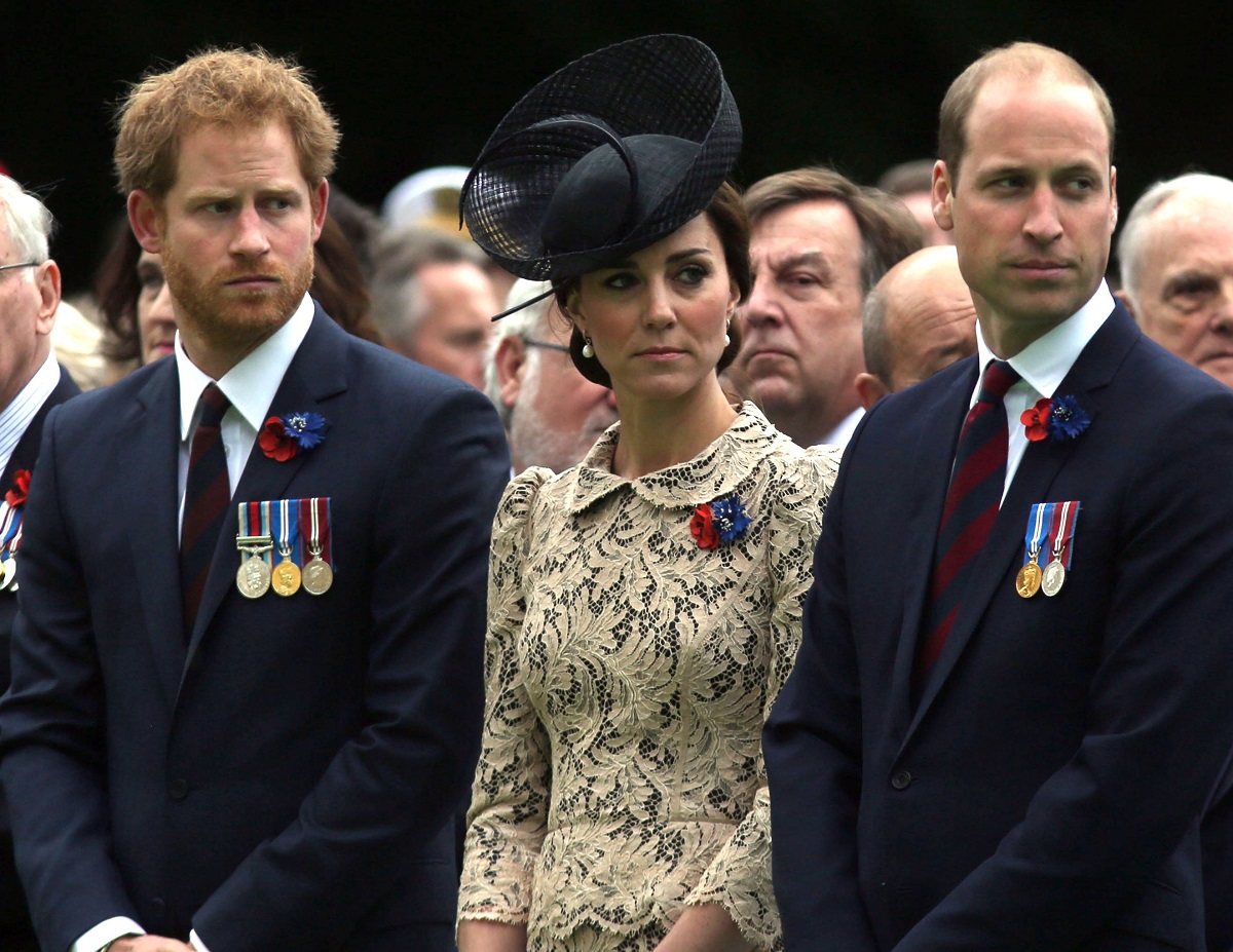 Prince Harry, Kate Middleton, and Prince William seated together during the Commemoration of the Centenary