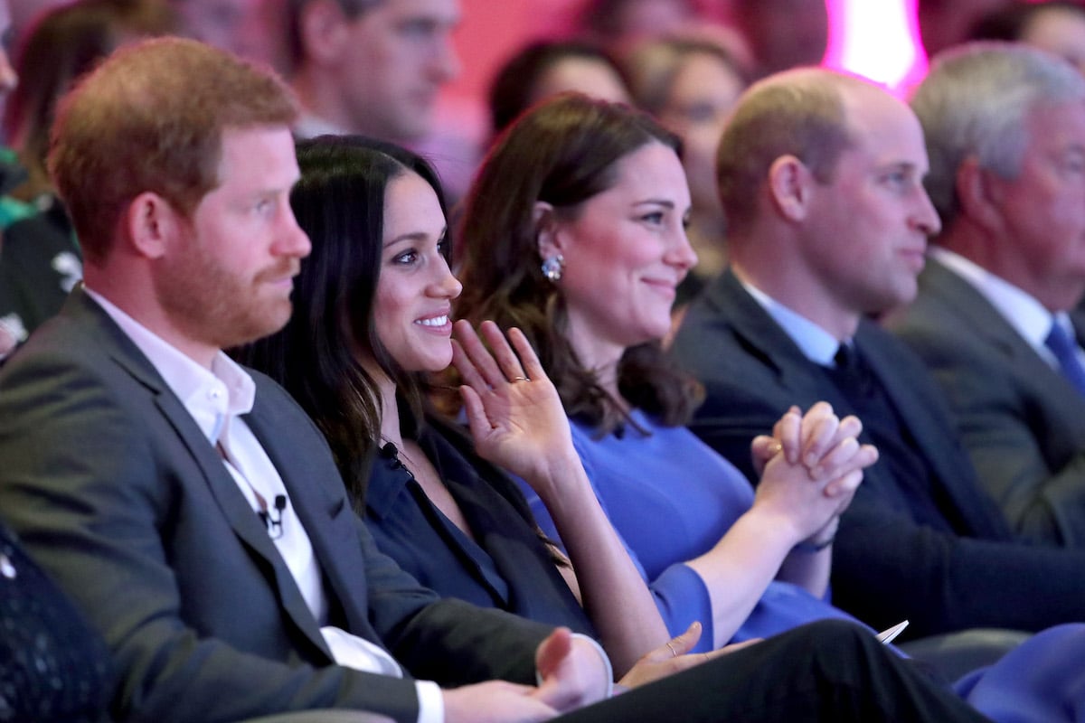 Prince Harry and Meghan Markle sit next to Kate Middleton and Prince William, who had a 'wake-up call' at Meghan Markle's first royal engagement, according to Katie Nicholl's 'New Royals' book,at the Royal Foundation panel forum in 2018