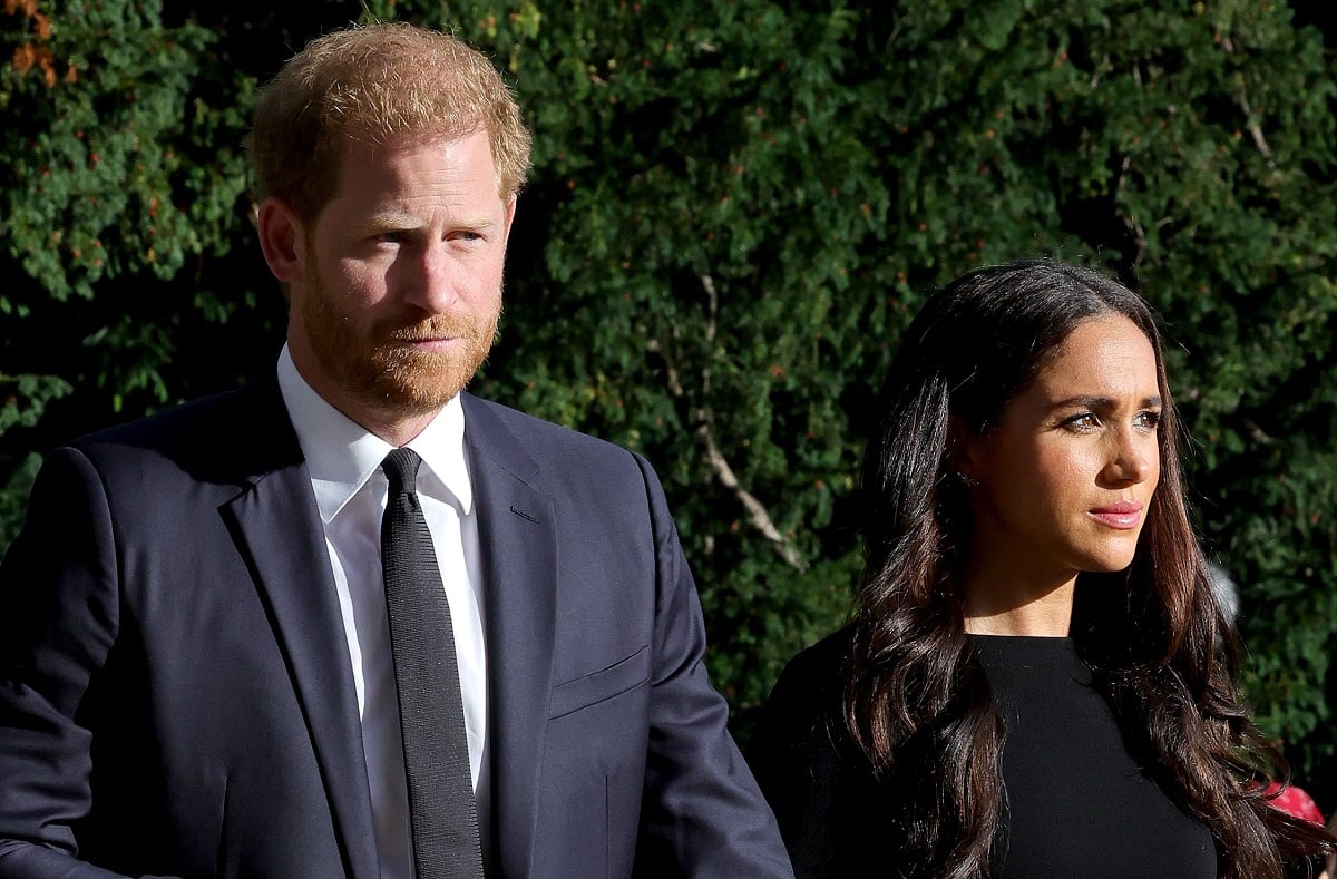 Prince Harry and Meghan Markle arriving on the long Walk at Windsor Castle to view flowers and tributes to Queen Elizabeth II