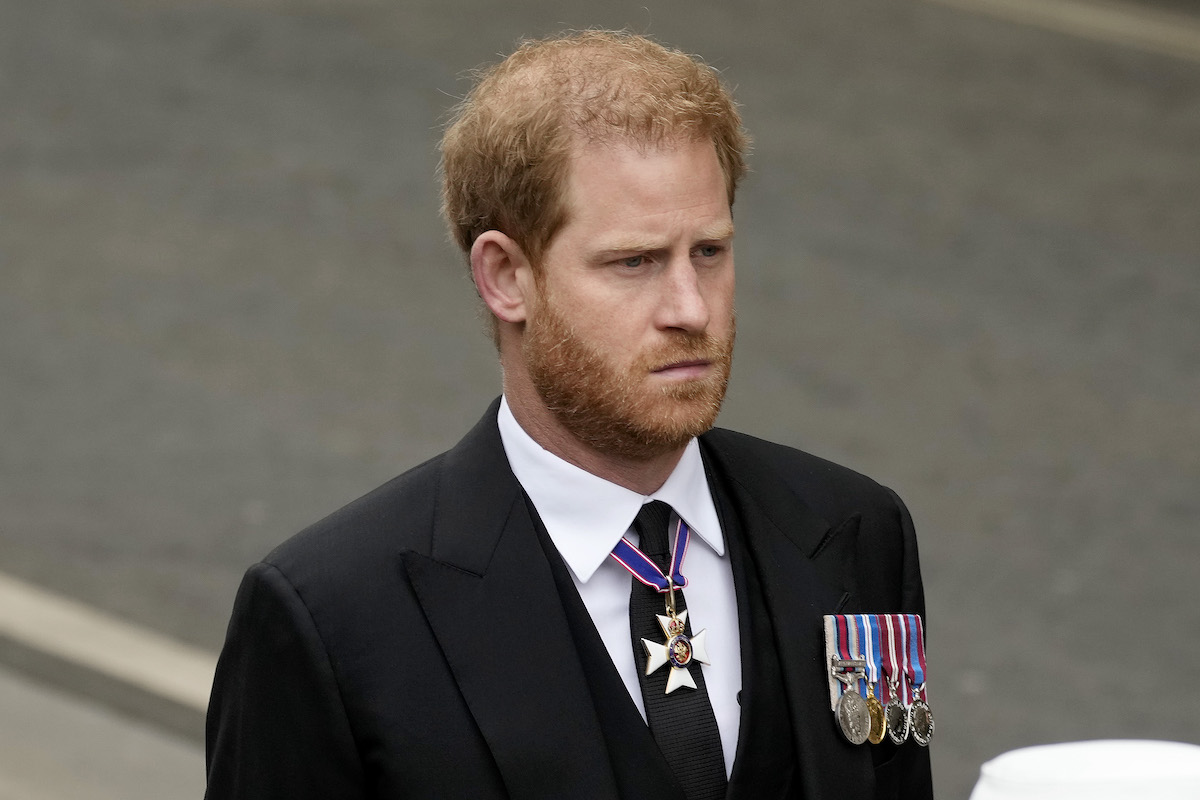 Prince Harry, whose original text to his book will 'always be a threat' for leaks according to a royal expert, walks in a procession during Queen Elizabeth's funeral