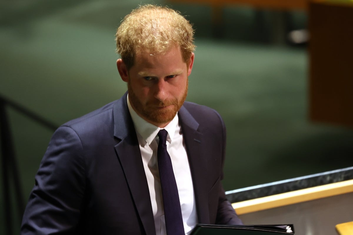 Prince Harry, who a commentator says looks miserable and may have failed to find happiness after stepping down, at podium after addressing the United Nations