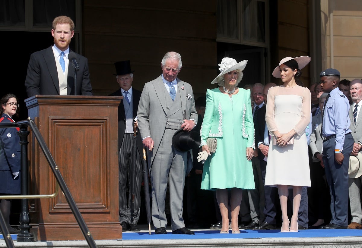 Prince Harry gives a speech next to then-Prince Charles, Camilla Parker Bowles, and Meghan Markle at Charles' 70th Birthday Patronage Celebration
