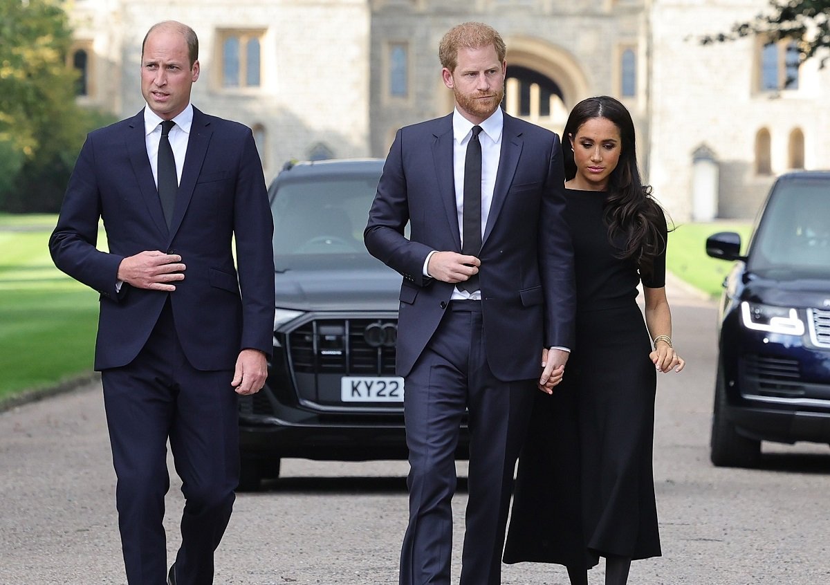 Prince William, Prince Harry, and Meghan Markle arrive to view flowers and tributes to Queen Elizabeth II at Windsor Castle