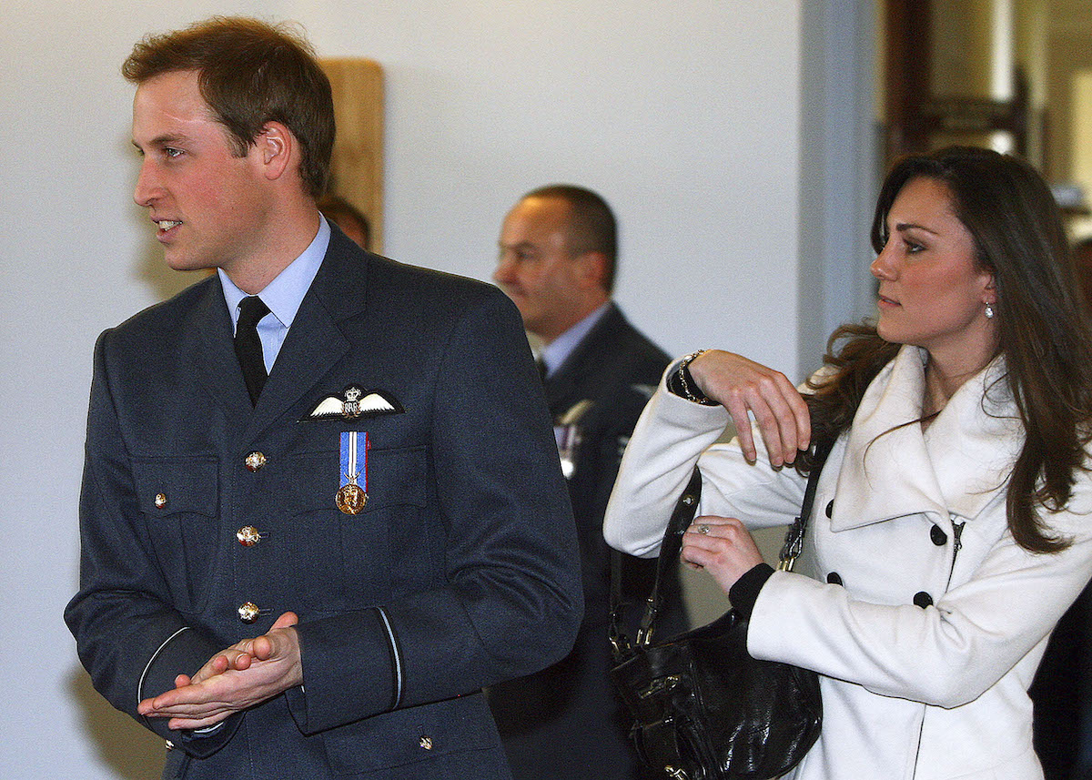 Kate Middleton, whose long courtship with Prince William was vital to her success in the royal family, according to Katie Nicholl, walks with Prince William in 2008
