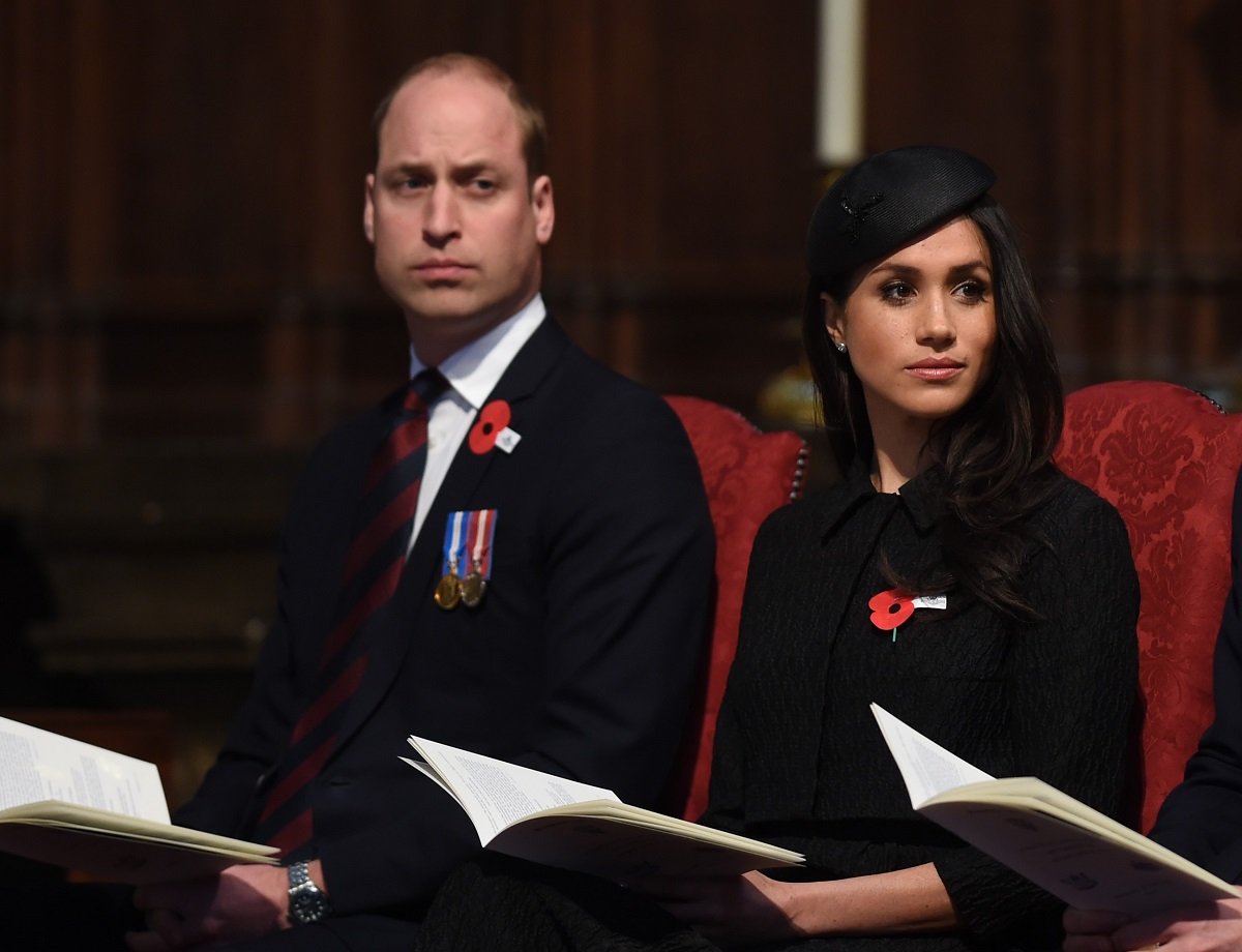 Prince William and Meghan Markle seated next to each other at an Anzac Day service