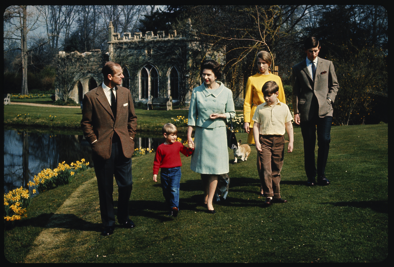 An informal group of the royal family on the grounds of Windsor Castle c. 1968. (L-R) Prince Philip, Prince Edward, Queen Elizabeth II, Prince Andrew, Princess Anne, and King Charles III.