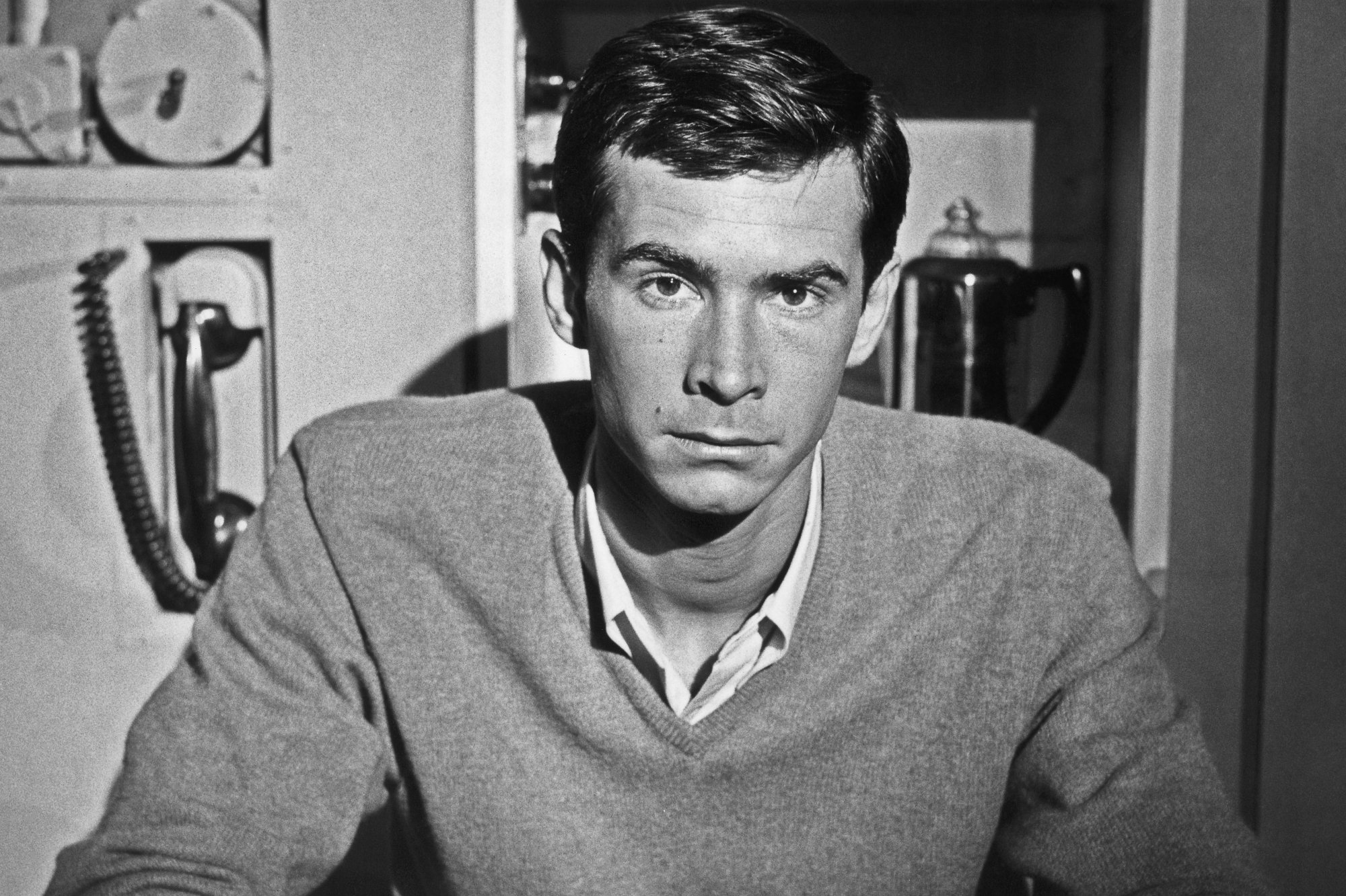 'Saturday Night Live' host Anthony Perkins wearing a sweater and collared shirt underneath with a serious look on his face.