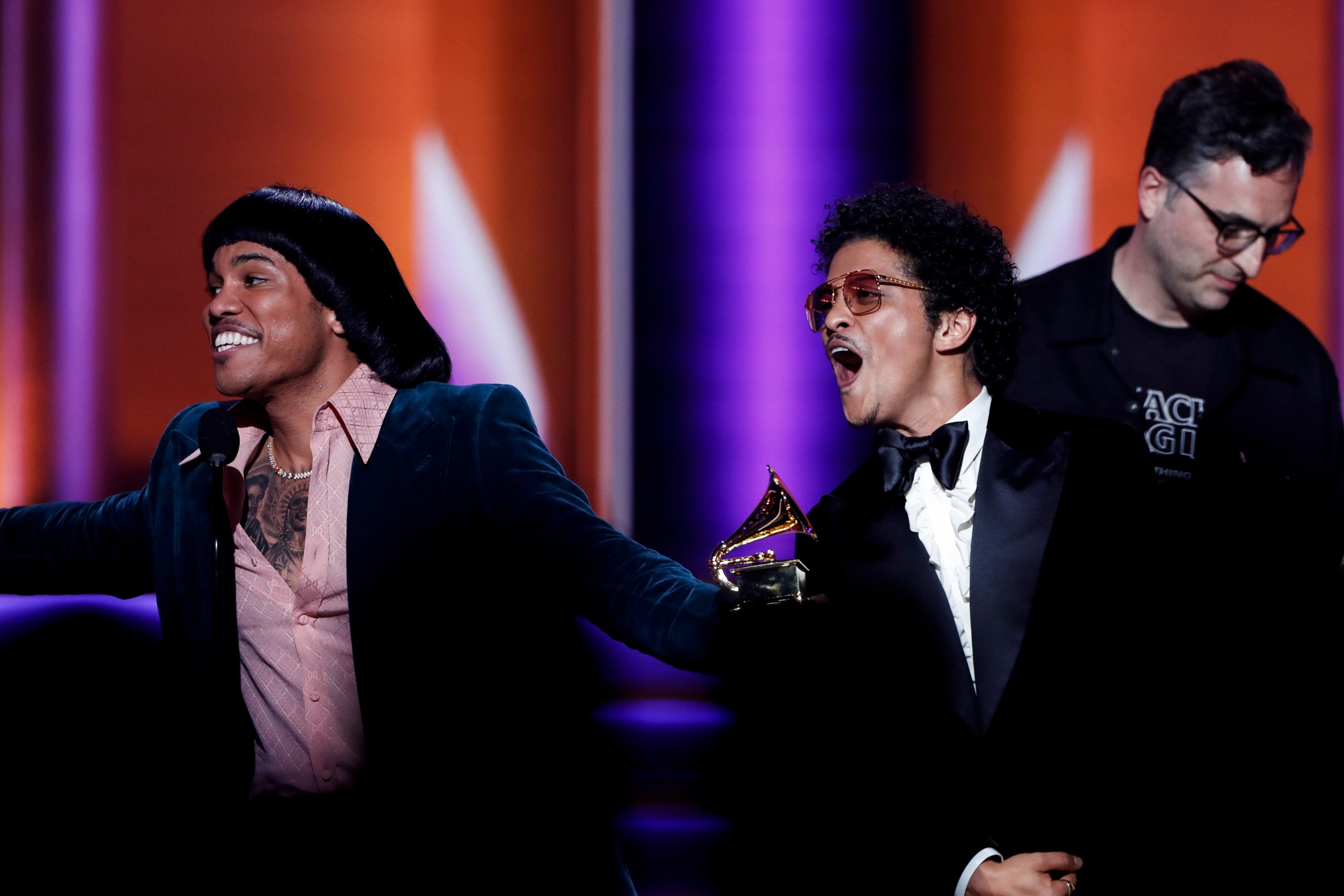 Anderson .Paak and Bruno Mars of Silk Sonic celebrate on stage with a Grammy Award
