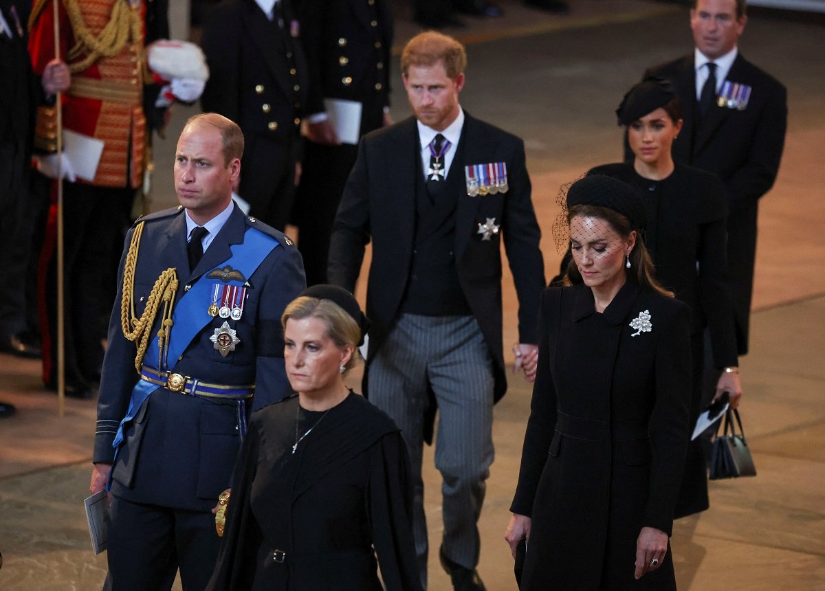 Sophie, Countess of Wessex; Prince William; Kate Middleton; Meghan Markle; Prince Harry; and Peter Phillips walk in a procession with the coffin of Queen Elizabeth at Westminster Hall