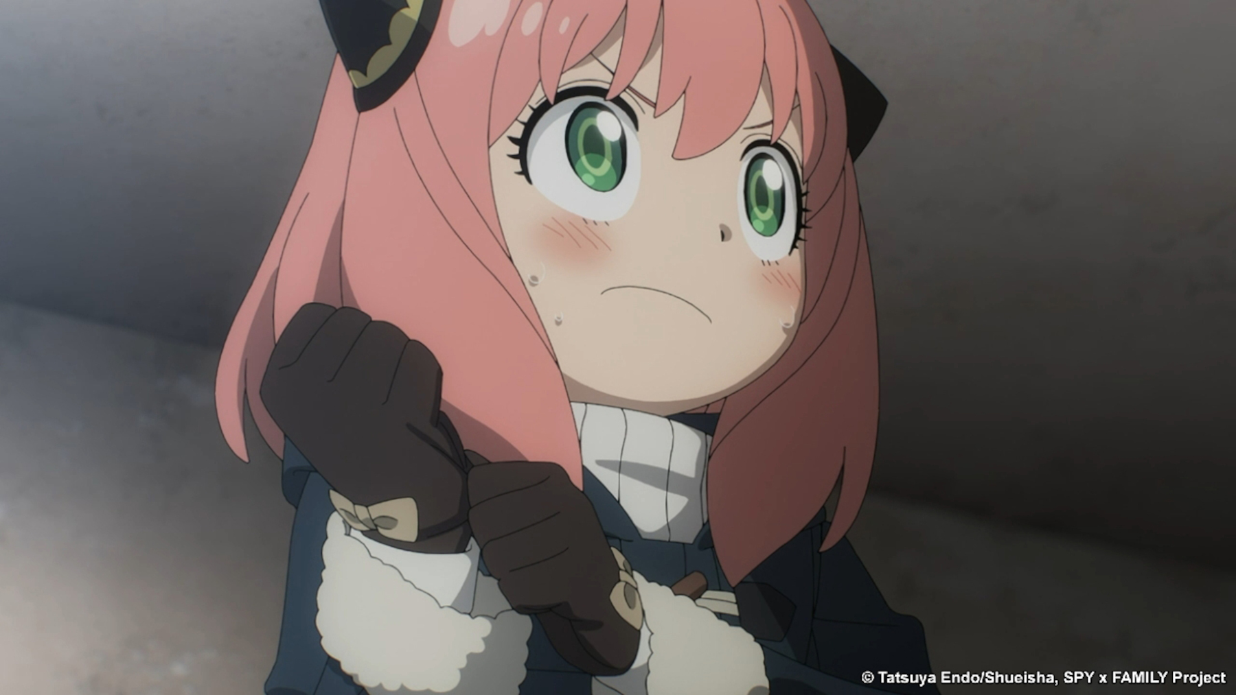 Anya Forger in 'Spy x Family,' which is 1 of our best anime streaming on Crunchyroll in October 2022. She's pulling a glove on and looks determined.