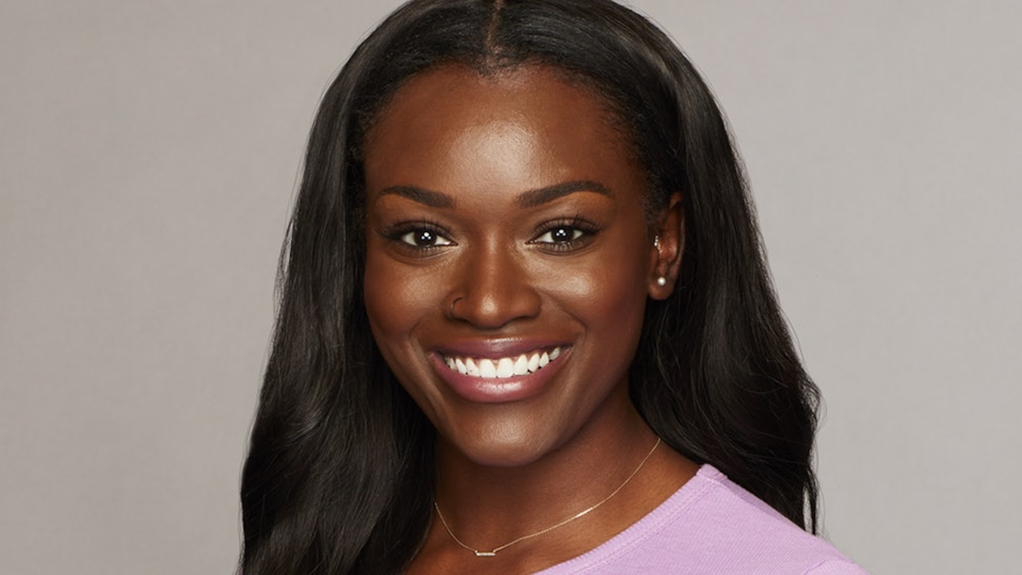 'The Bachelor' star Tahzjuan Hawkins wearing a pink shirt in a promotional photo