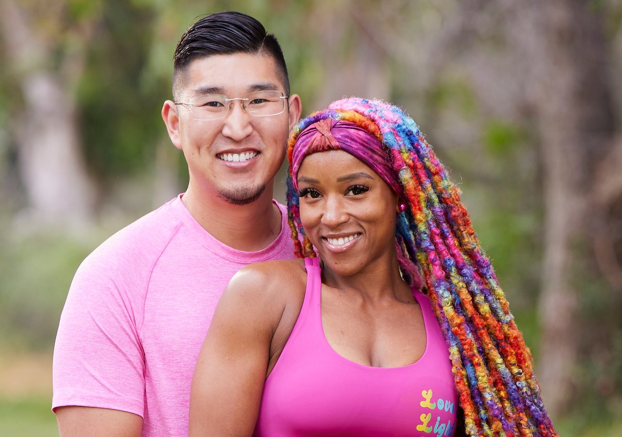 Rich Kuo and Dom Jones on 'The Amazing Race' Season 34 pose together in pink outfits.