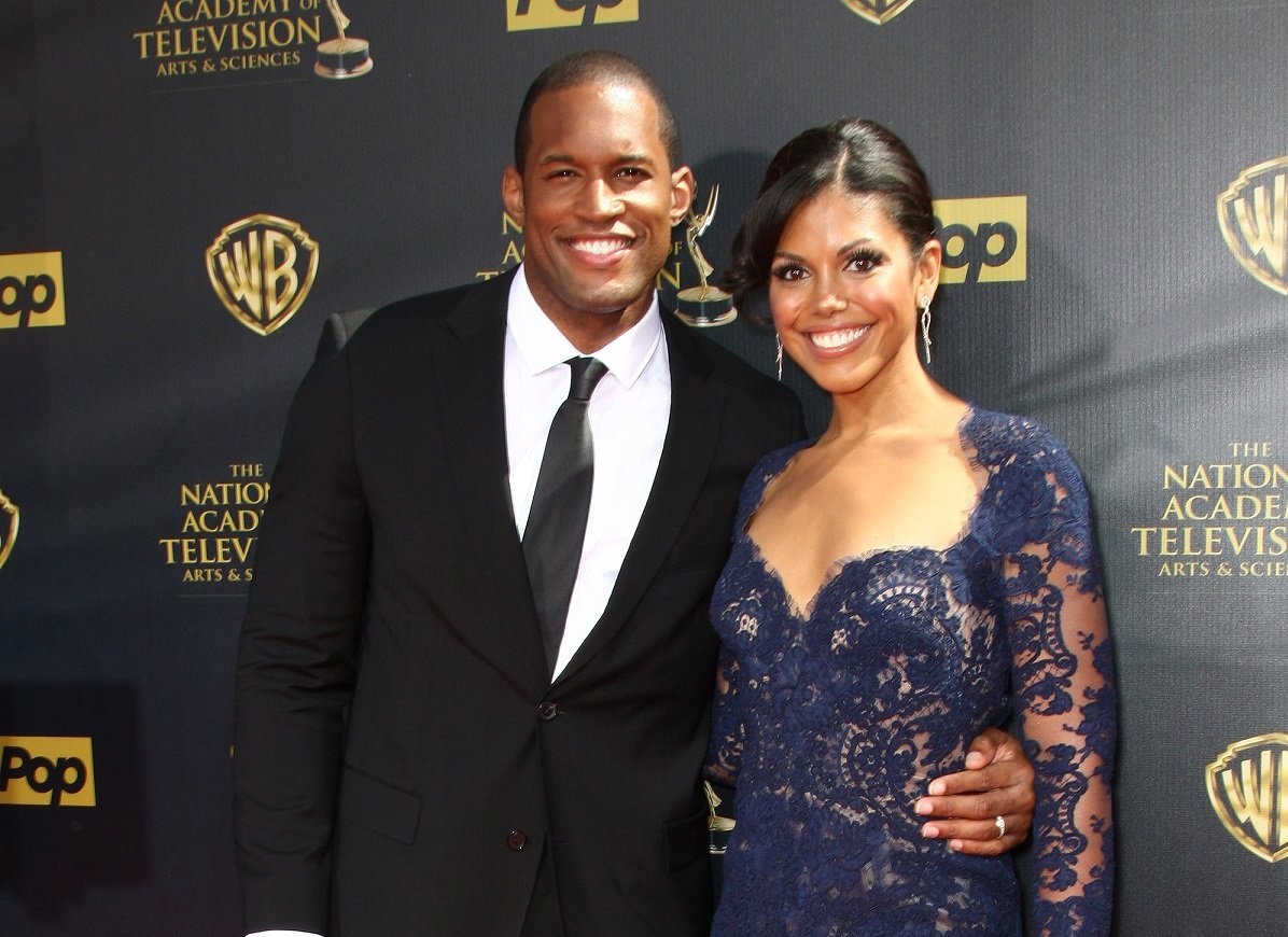 'The Bold and the Beautiful' star Lawrence Saint-Victor in a tuxedo and Karla Mosley in a blue dress; pose together for a photo.