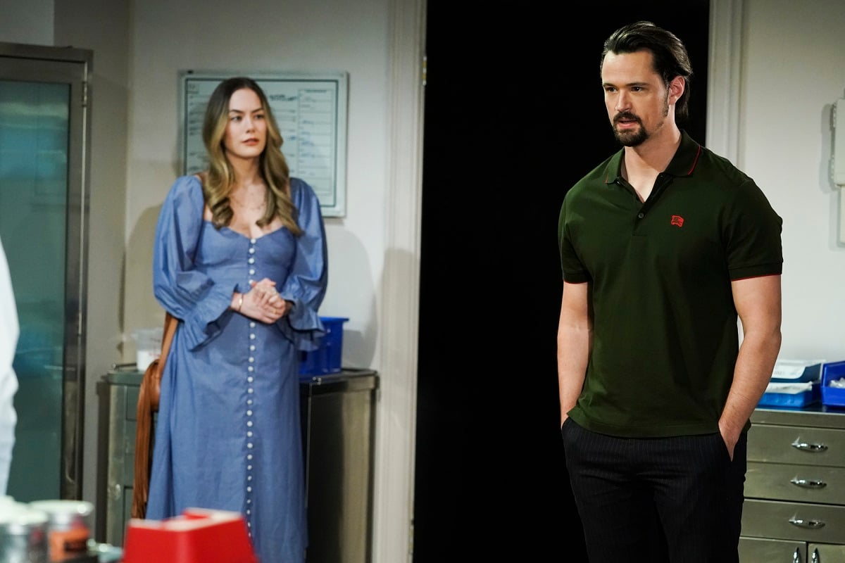 'The Bold and the Beautiful' star Annika Noelle in a blue dress and Matthew Atkinson in a green shirt film a scene from the soap opera.