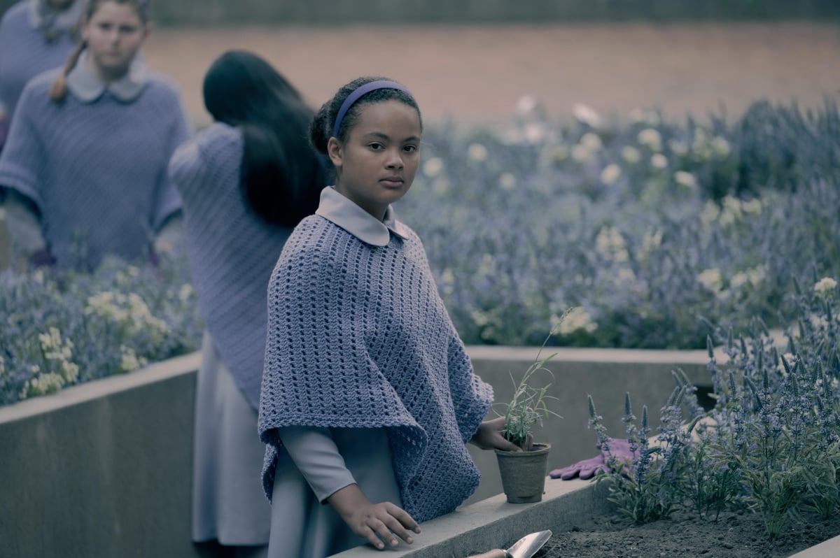 June faces an impossible decision in The Handmaid's Tale Season 5 Episode 8. Hannah plants flowers outside at the Wives School.