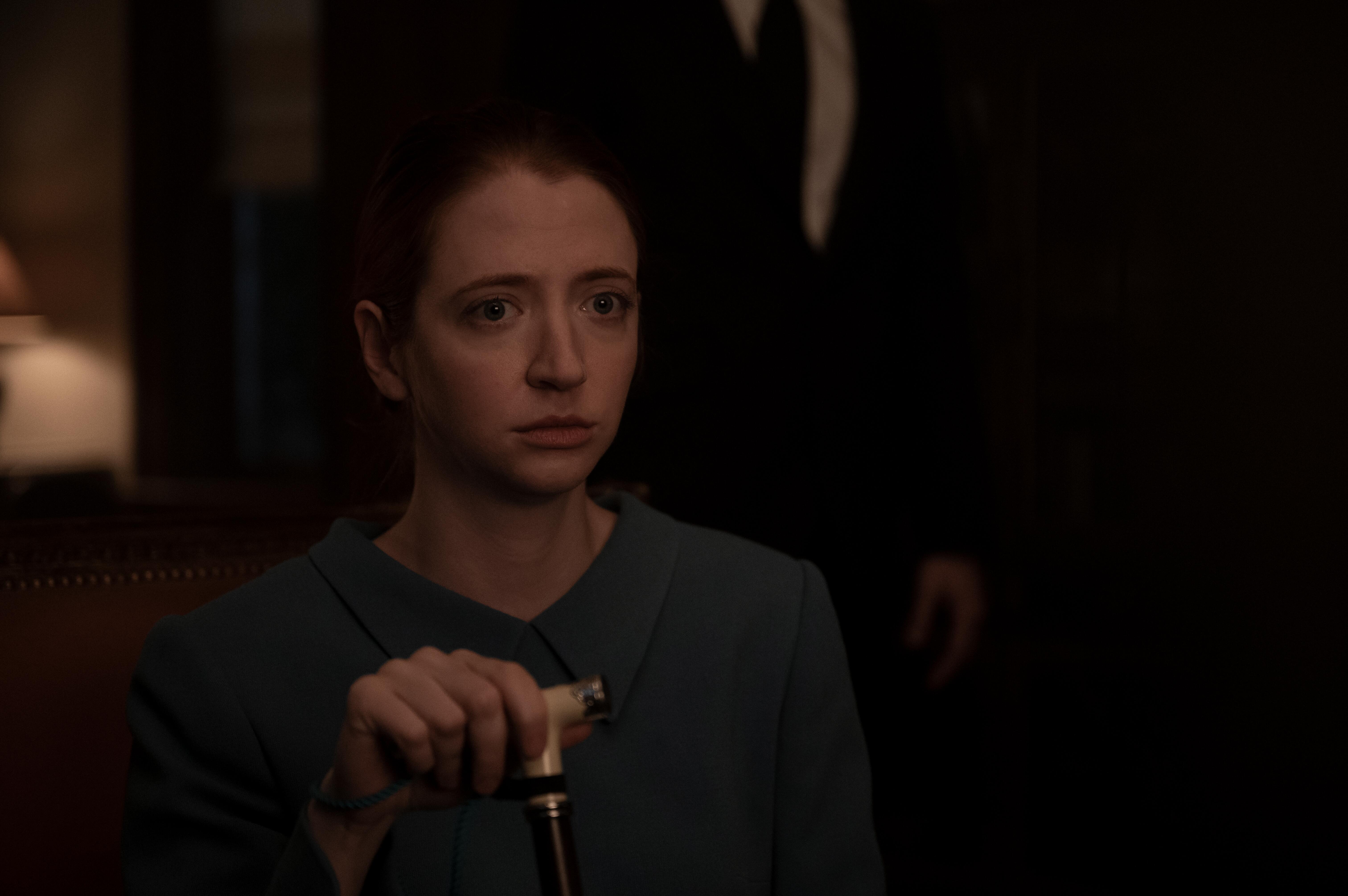 Nick's wife Rose holds her cane while sitting down in 'The Handmaid's Tale'
