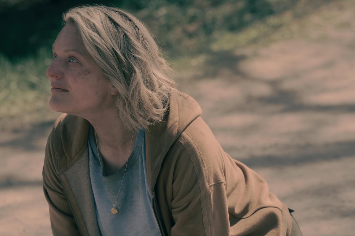 The Handmaid's Tale Season 5 Episode 6 ending explained. June kneels on the ground, covered in dirt.