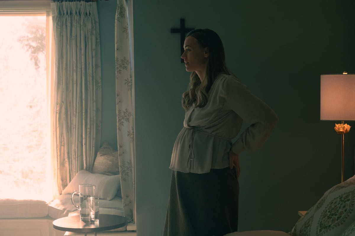 Yvonne Strahovski as Serena Joy Waterford in The Handmaid's Tale. A pregnant Serena Joy stands in her room at the Wheeler's house.