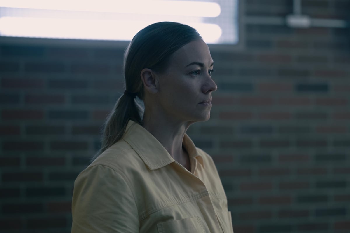 Yvonne Strahovski as Serena Joy in The Handmaid's Tale Season 5. Serena wears a yellow button-down shirt and has her hair in a ponytail.