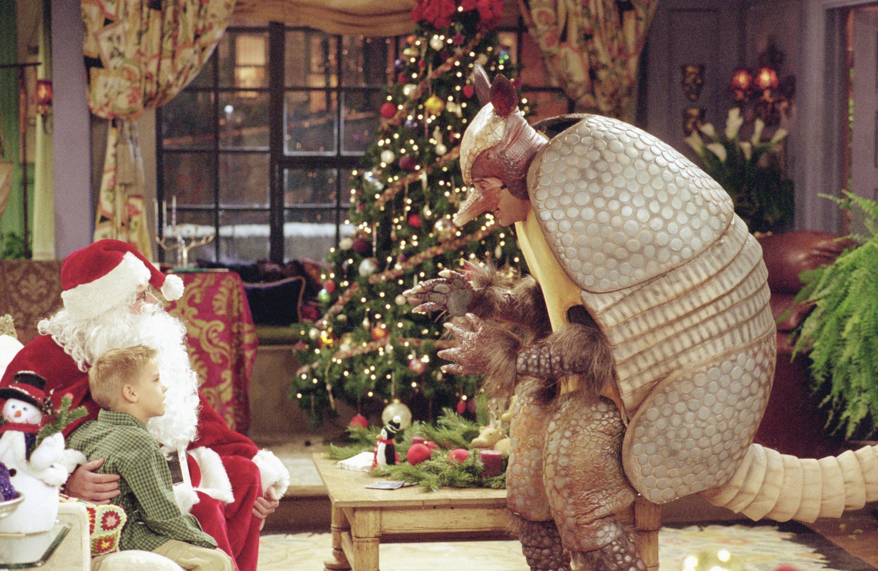 Cole Sprouse as Ben Geller, Matthew Perry as Chandler Bing as "Santa Claus", David Schwimmer as Ross Geller as "The Holiday Armadillo