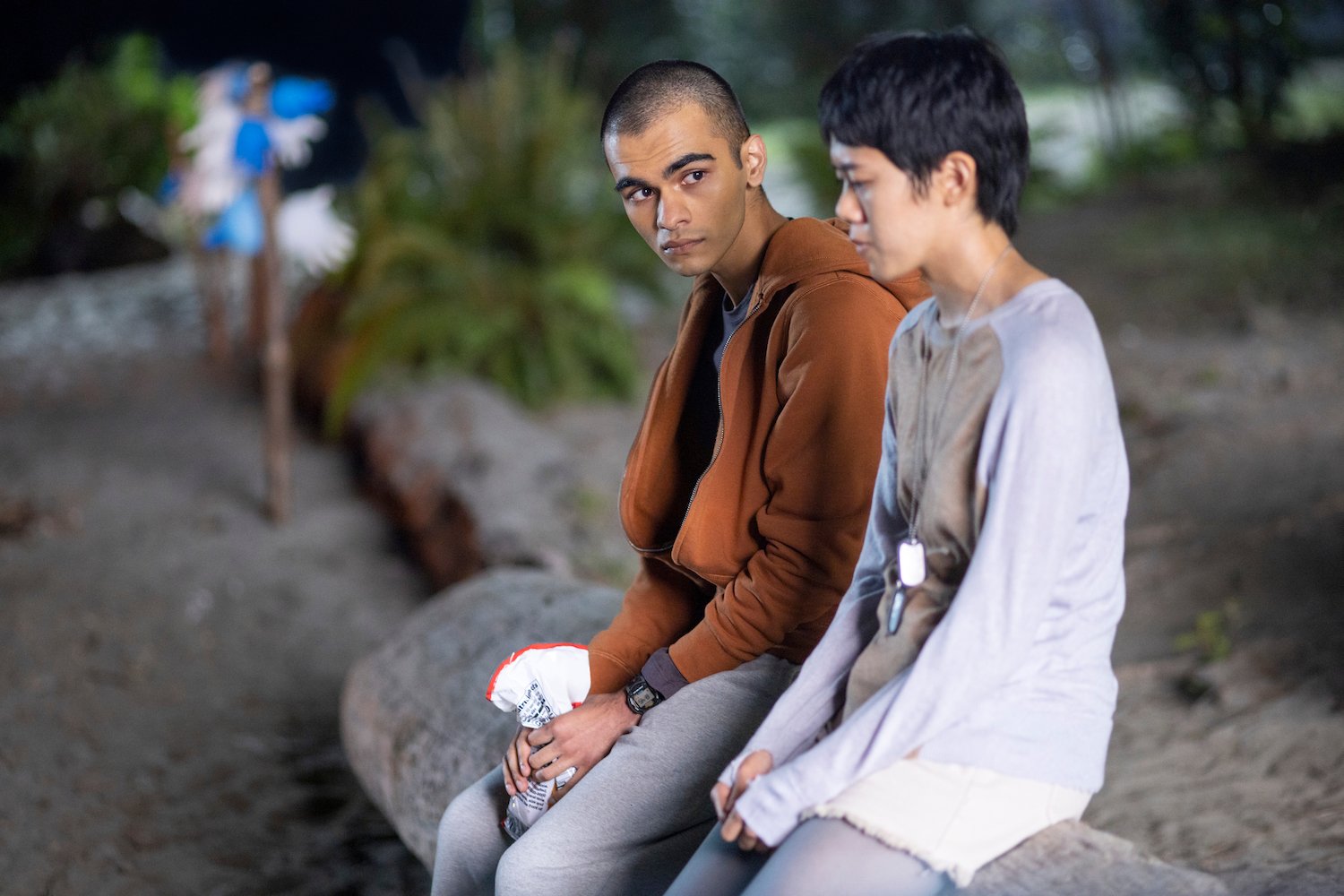 In 'The Midnight Club,' Amesh's story has an underlying meaning. Sauriyan Sapkota and Aya Furukawa, who play Amesh and Natsuki, are seen here sitting on a rock at a beach.