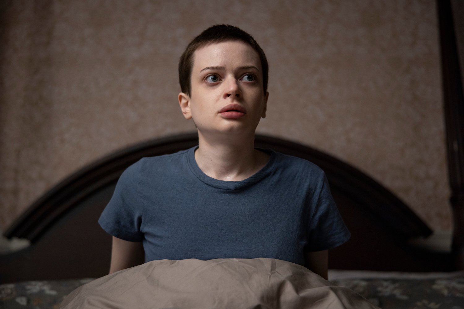 In 'The Midnight Club,' Anya's story touches on the guil she feels over her parents' death. Anya's seen here wearing a blue tshirt and sitting bed.