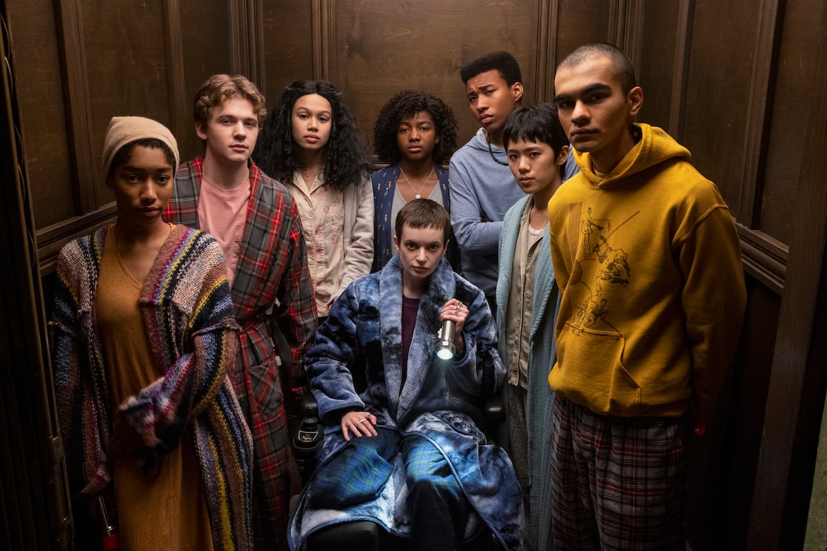 Mike Flanagan changed several things from 'The Midnight Club' novel. Here, the cast from the Netflix series stands looking out from inside an elevator in a production still.