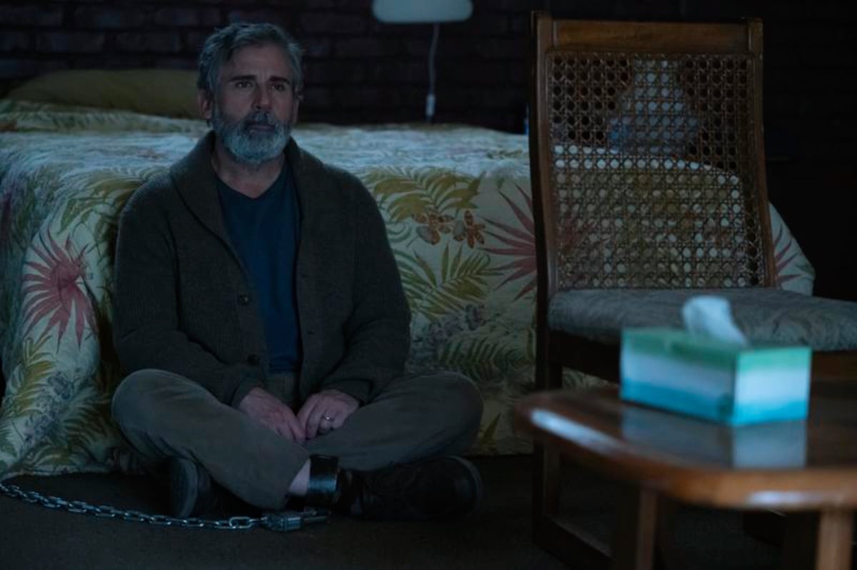 In The Patient Episode 7, Alan Strauss sits on the floor in front of a bed while chained to the floor in Sam's basement.