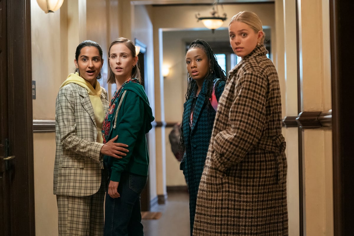 'The Sex Lives of College Girls' cast standing in a hallway looking surprised