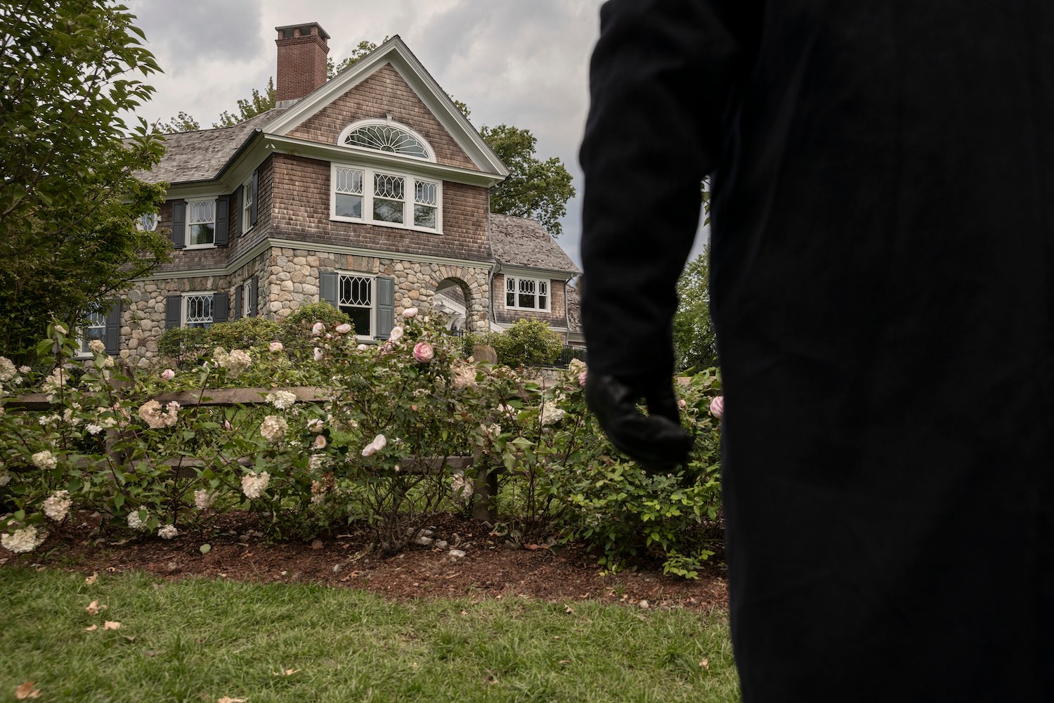 A dark figure watches a house in 'The Watcher' photo from the Netflix true crime drama