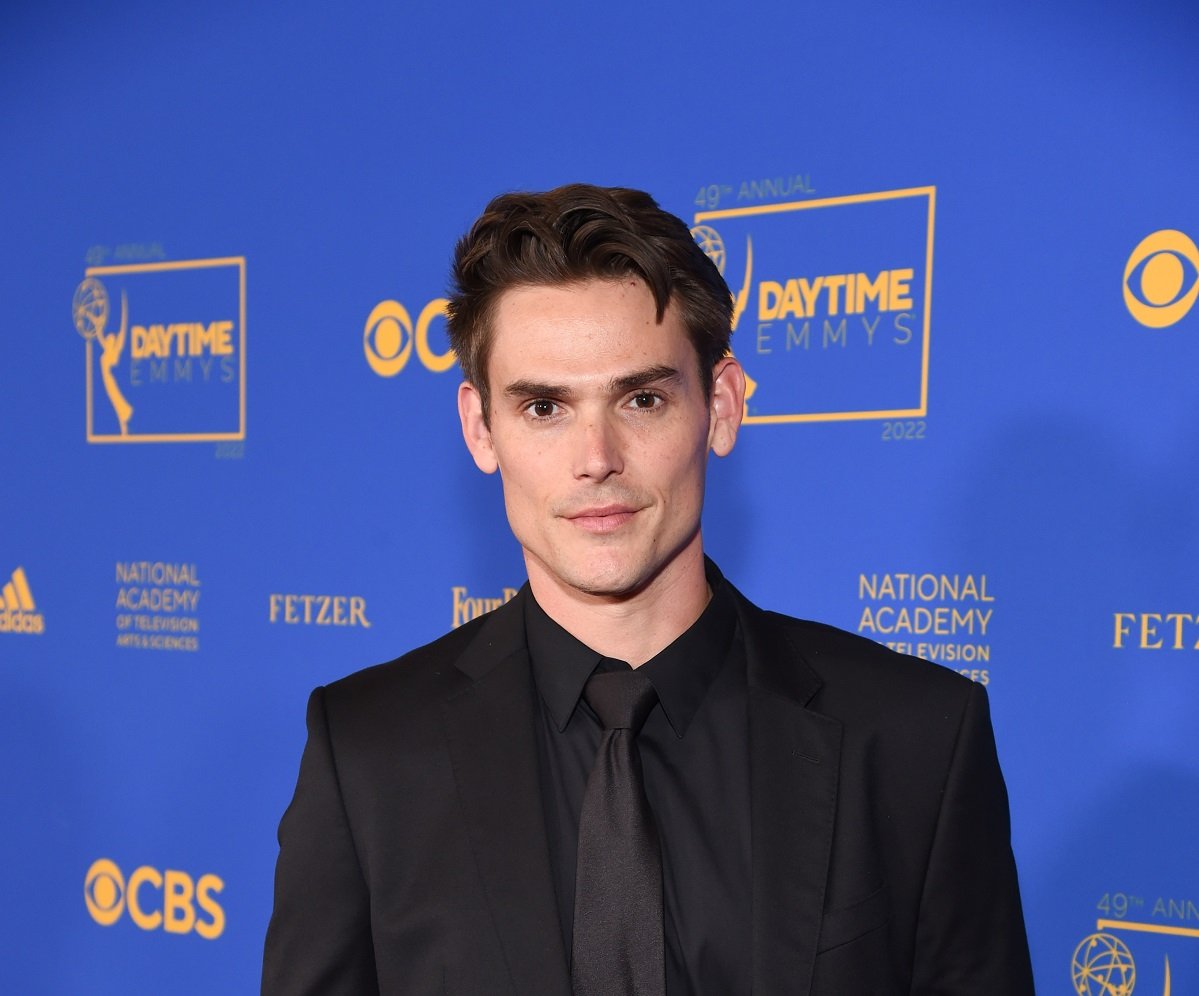 'The Young and the Restless' star Mark Grossman wearing a black suit and posing on the red carpet of the 2022 Daytime Emmys.