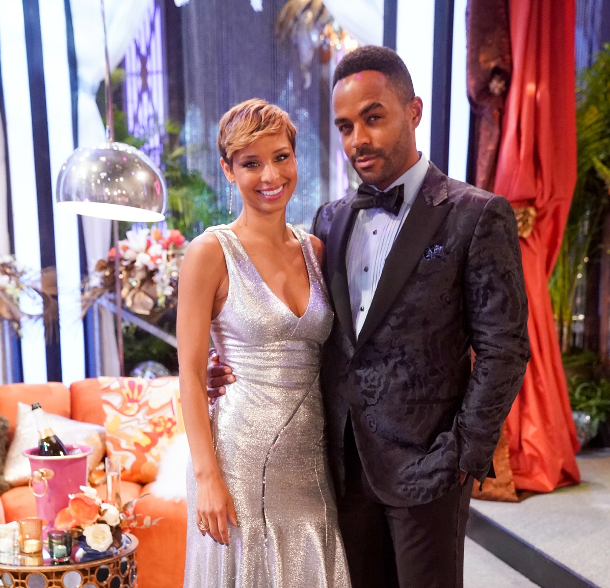 'The Young and the Restless' star Brytni Sarpy in a silver dress and Sean Dominic in a tuxedo pose on set of the soap opera.