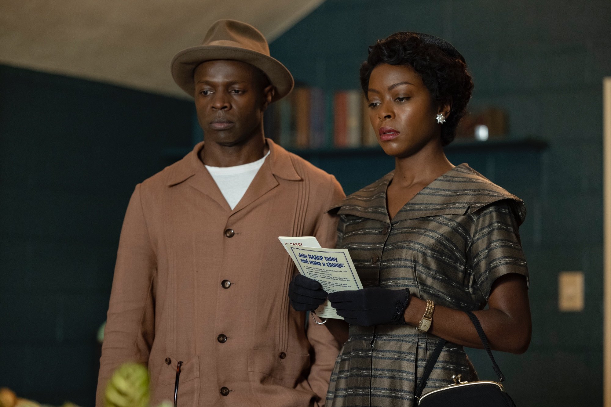 'Till' Sean Patrick Thomas as Gene Mobley and Danielle Deadwyler as Mamie Till-Mobley with a serious look on their faces. Deadwyler is holding NAACP pamphlets.