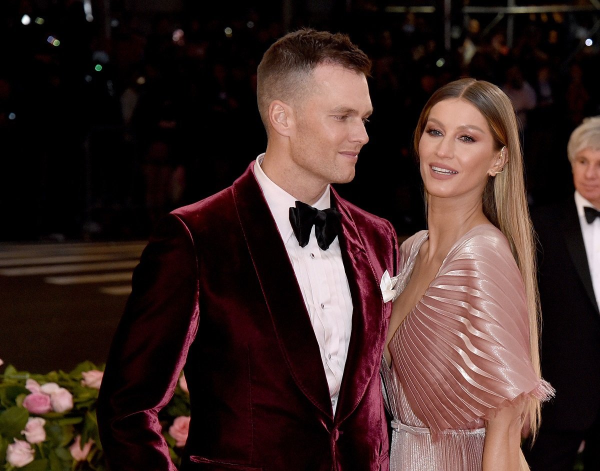 Tom Brady and Gisele Bündchen, who dated another athlete before marrying Brady, pose on the carpet at the Met Gala