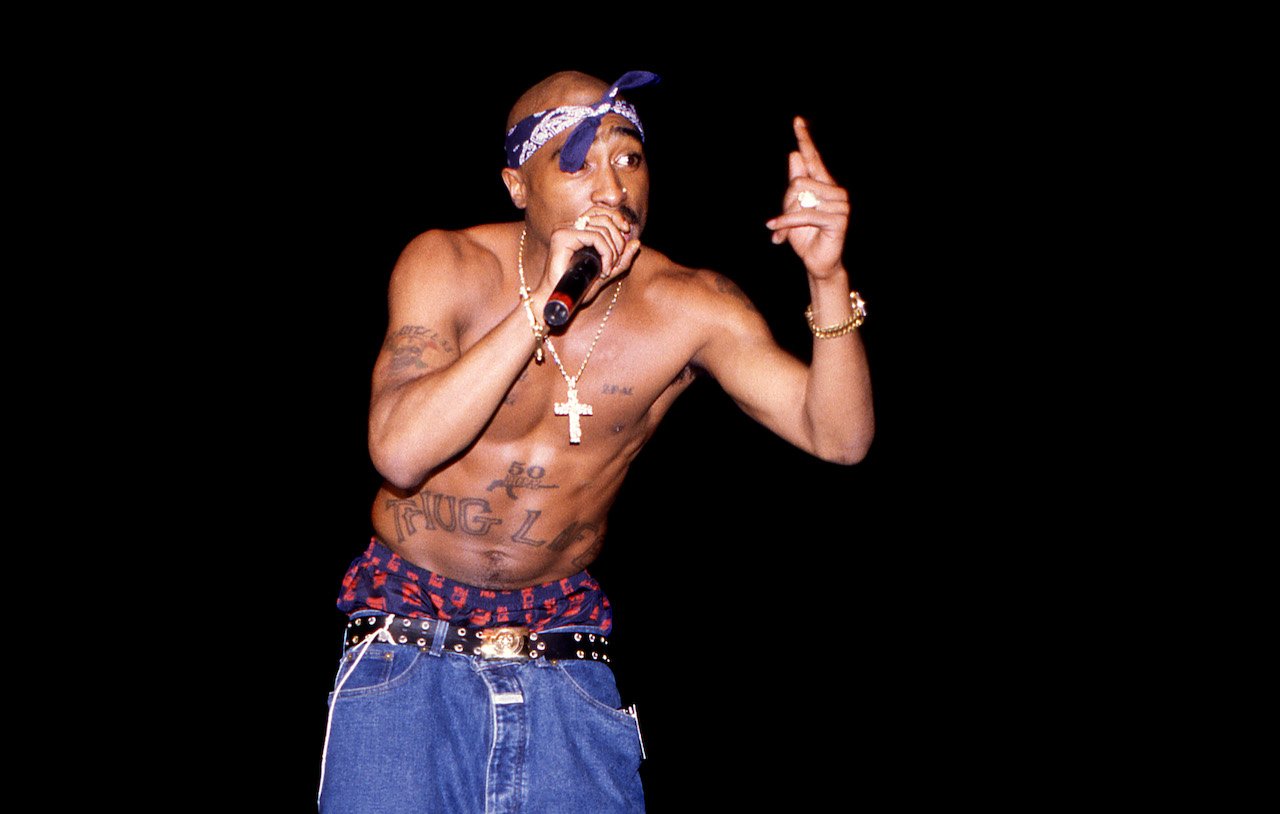 Tupac Shakur performs on stage; a new docuseries from Allen Hughes includes their fallout