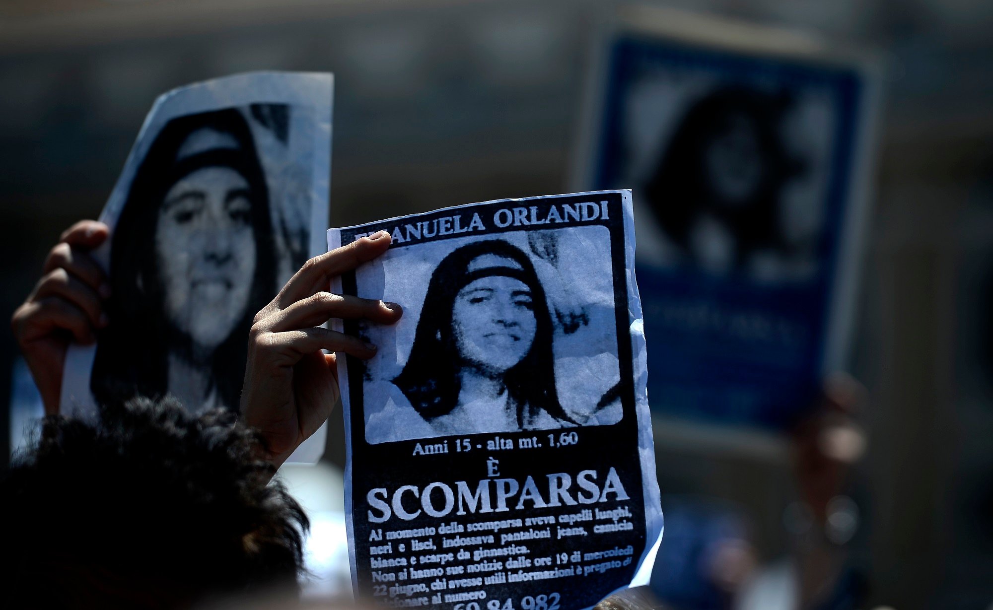 A demonstrator holds a poster of Emanuela Orlandi reading "Missing" during Pope Benedict XVI's Regina Coeli noon prayer in St. Peter's square, at the Vatican on May 27, 2012.