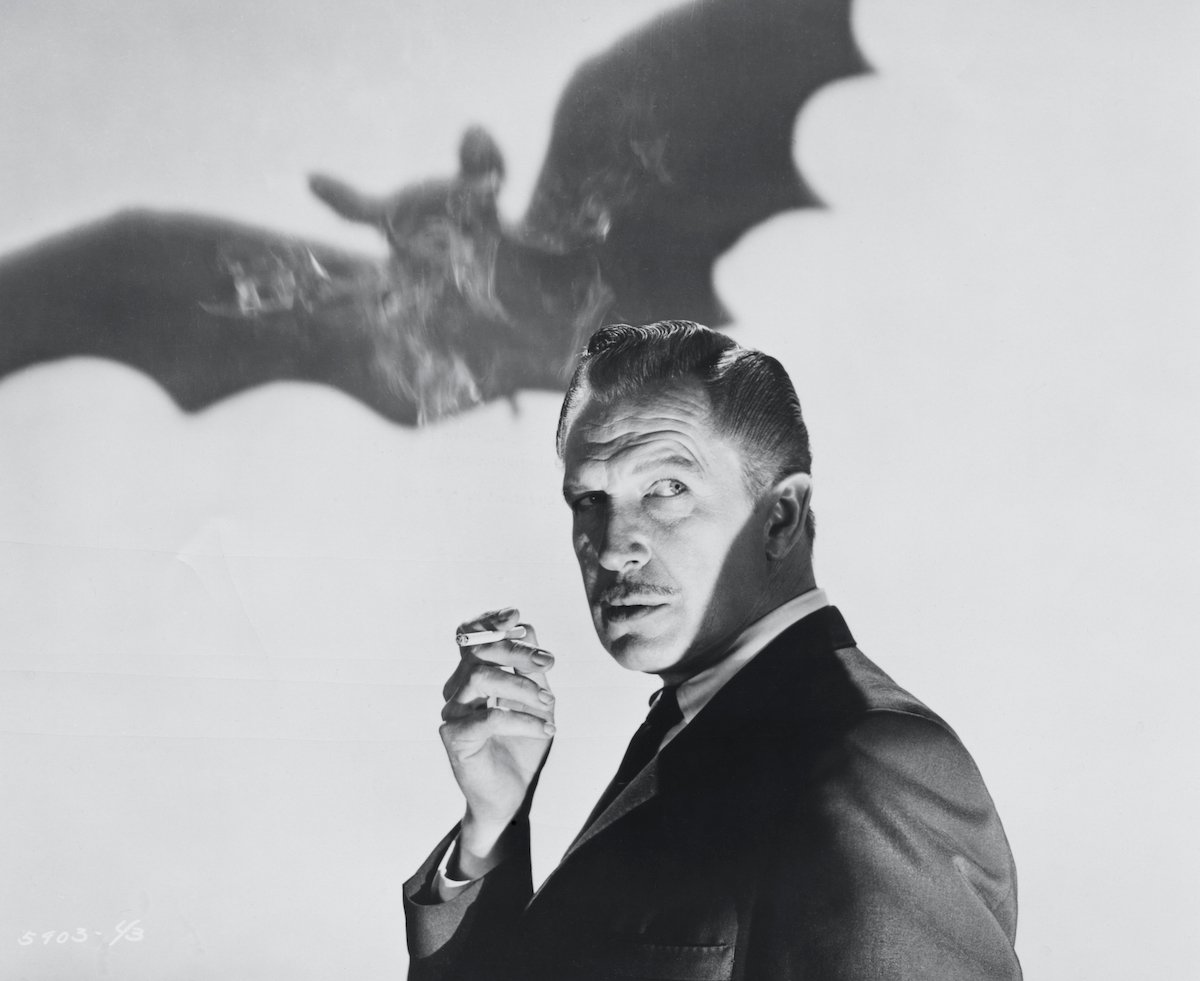 Black and white photo of Vincent Price in front of a silhouetted bat