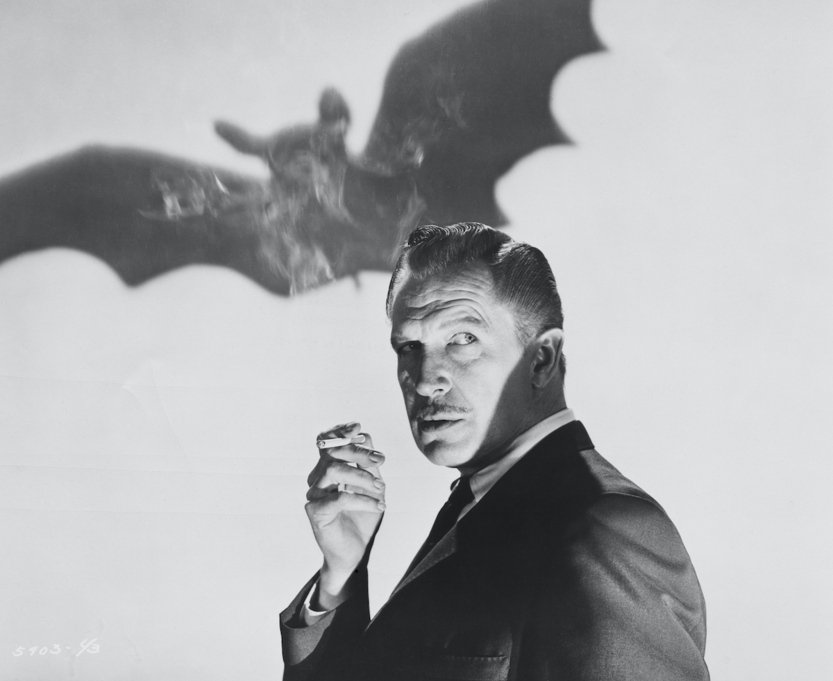 Black and white photo of Vincent Price in front of a silhouetted bat
