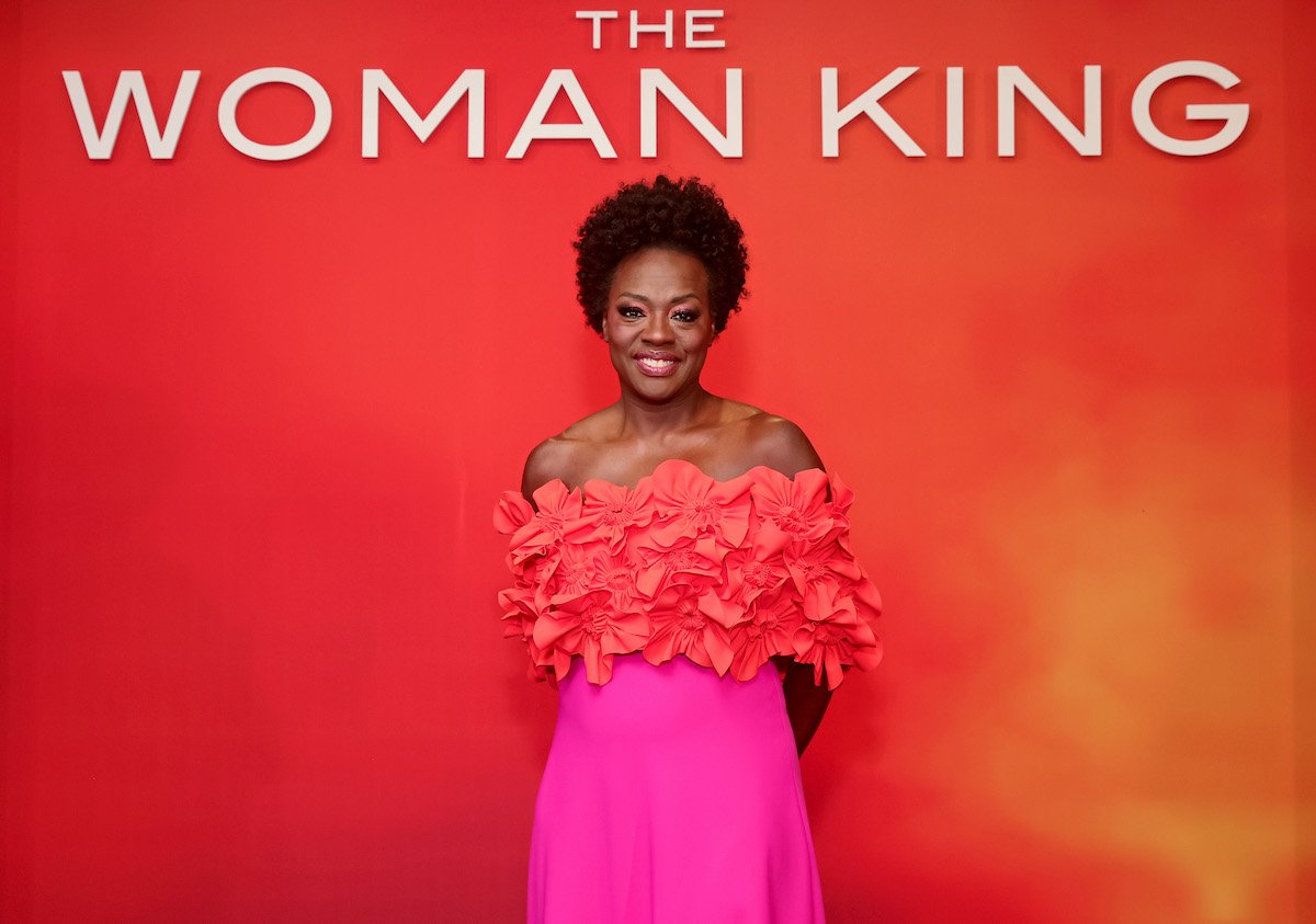 Actor Viola Davis attends "The Woman King" premiere in a bright orange and pink dress