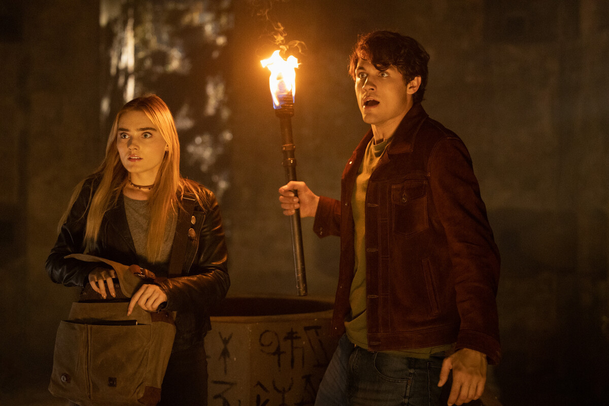 'The Winchesters': Drake Rodger holds a torch and Meg Donnelly reaches into her bag in the 'Supernatural' prequel