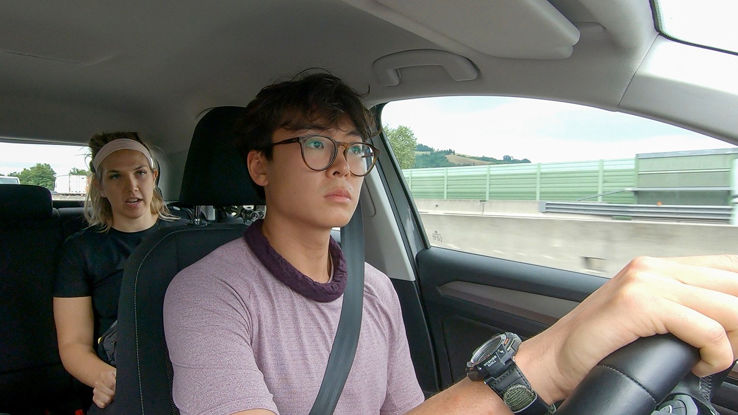 Claire Rehfuss sits in the backseat while Derek Xiao drives a car on The Amazing Race Season 34.