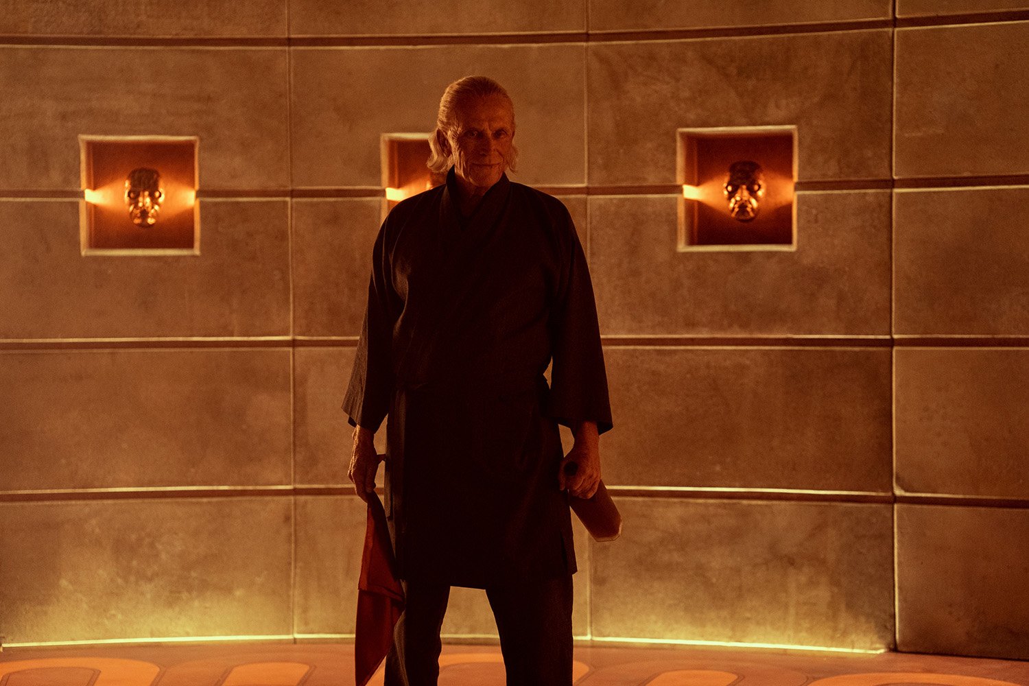 Peter Weller as Lassiter standing in a gold room in Guillermo del Toro's Cabinet of Curiosities
